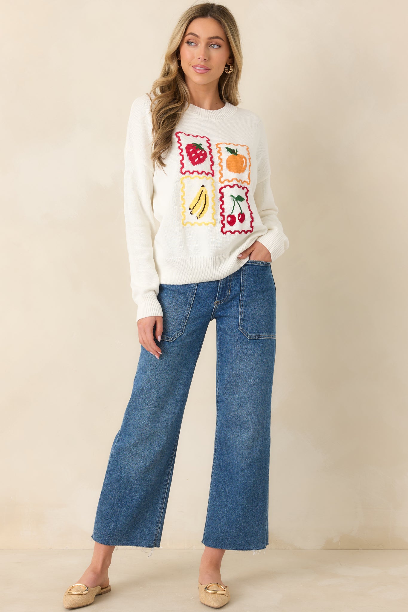 Soft white knit top with vintage-style fruit prints and classic crew neckline.
