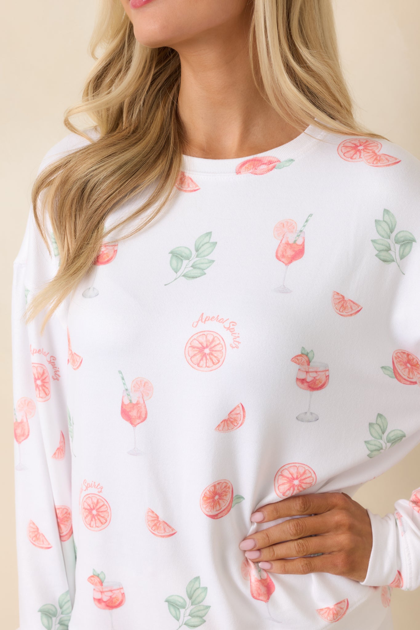 White pajama top detail showing citrus and cocktail print on lightweight fabric.