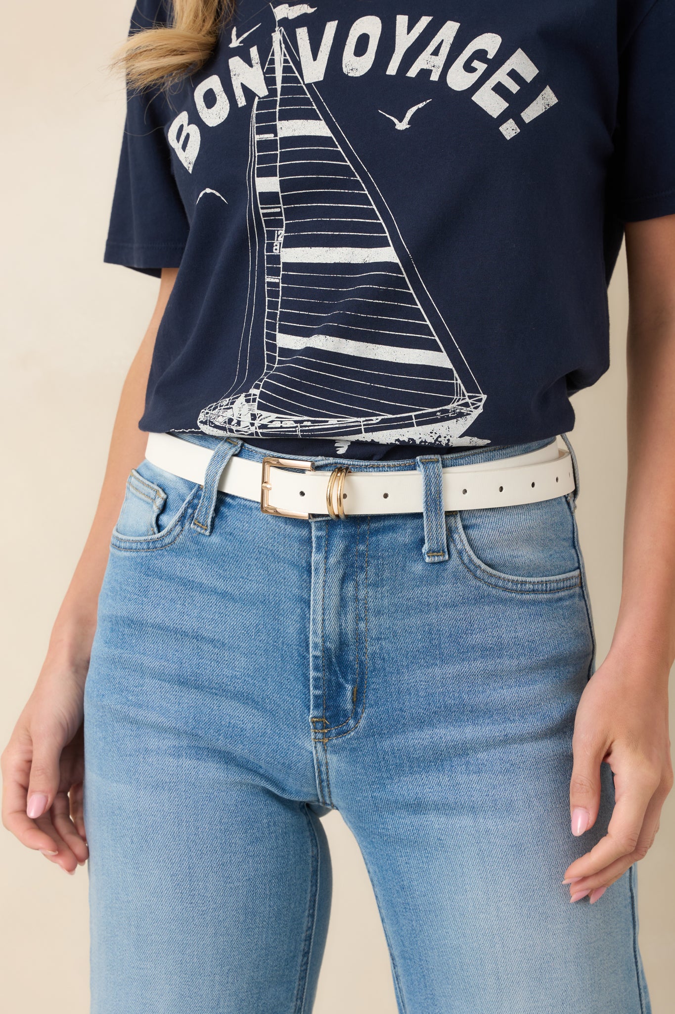 White slim faux leather belt featuring a polished gold-tone square buckle and double metal loop detail.