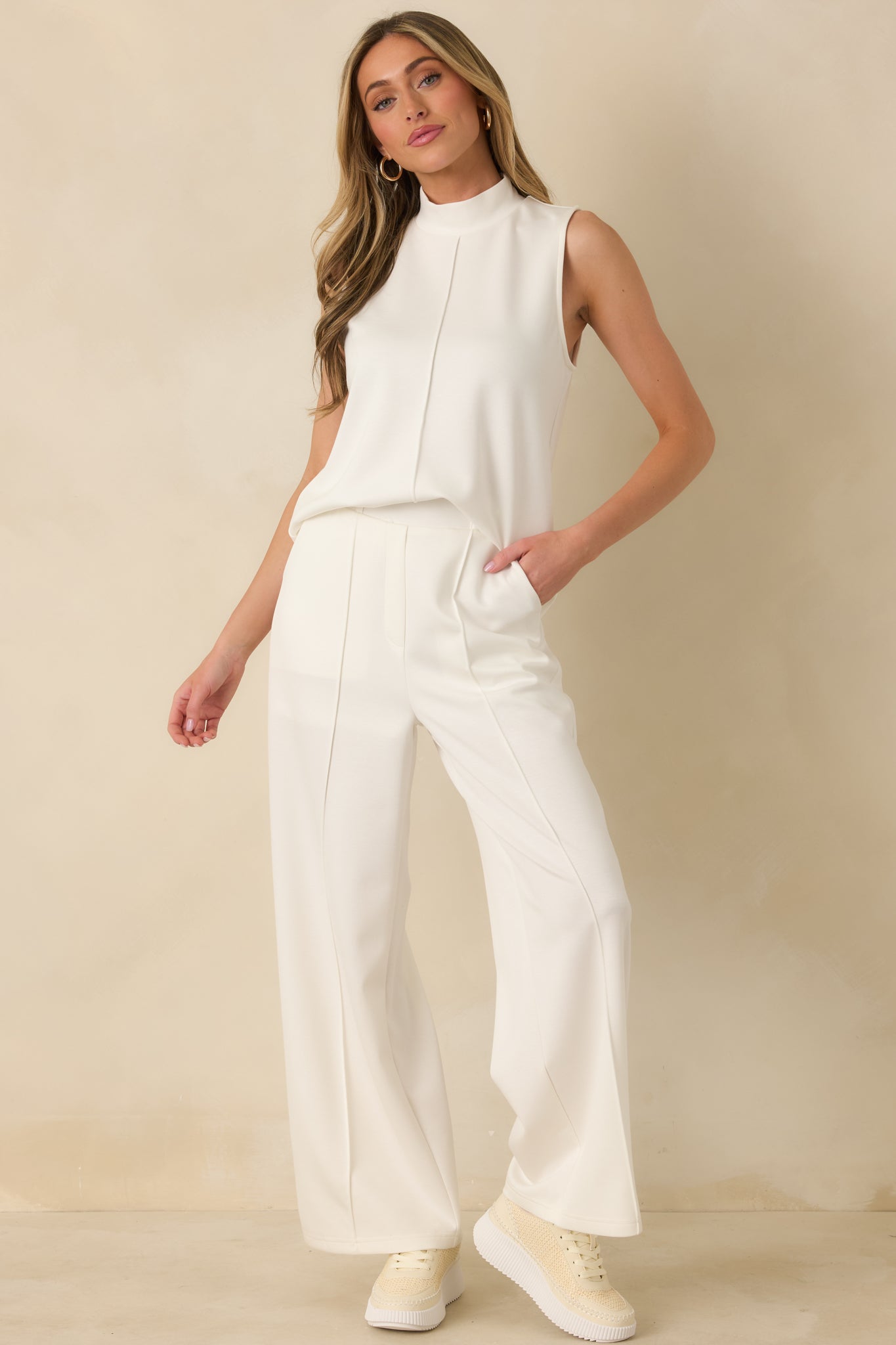 White tank top designed with a minimalist sleeveless shape and an easy, clean drape through the body.