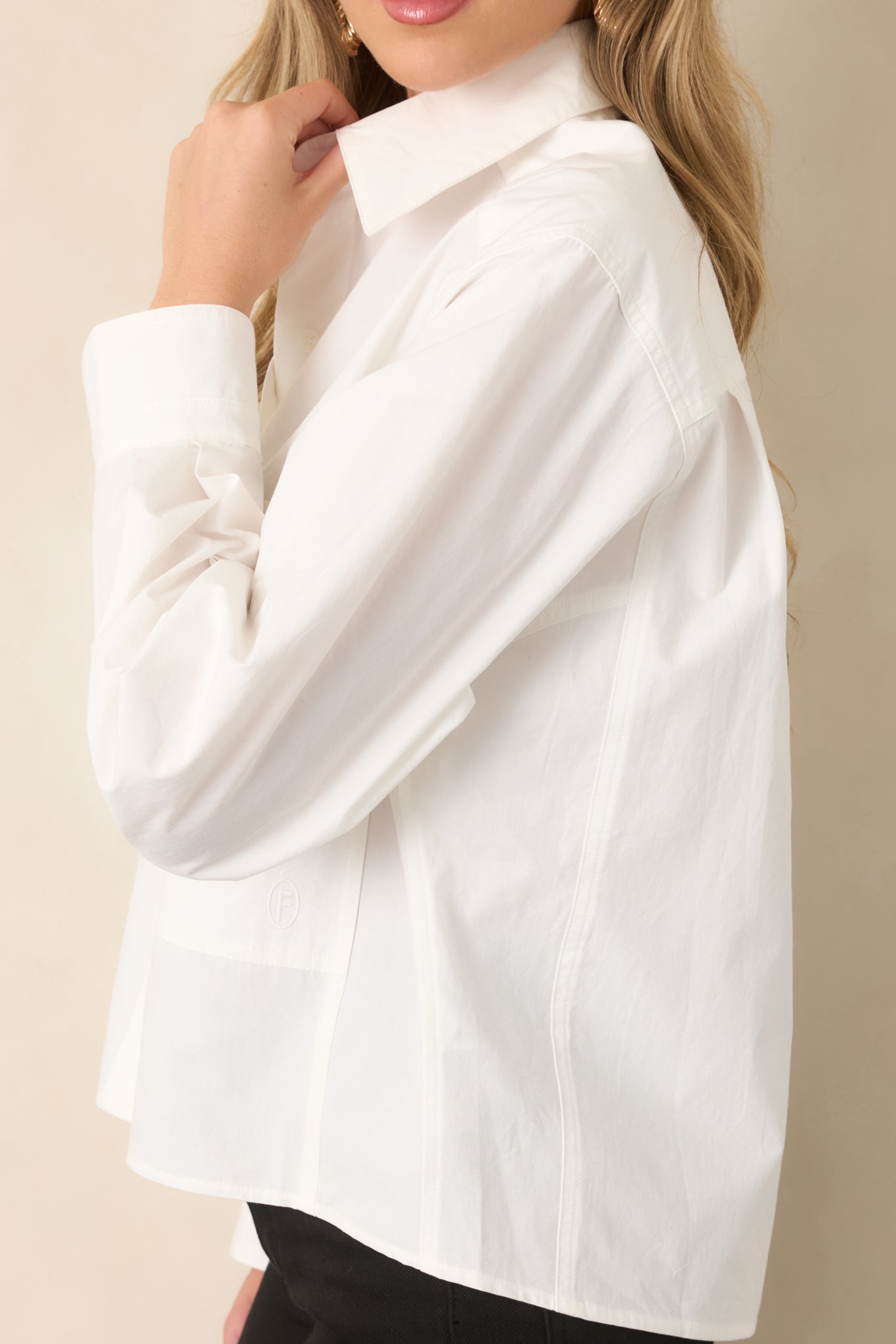 Long sleeve detail featuring a wide cuff with a slit opening and structured button-front construction.