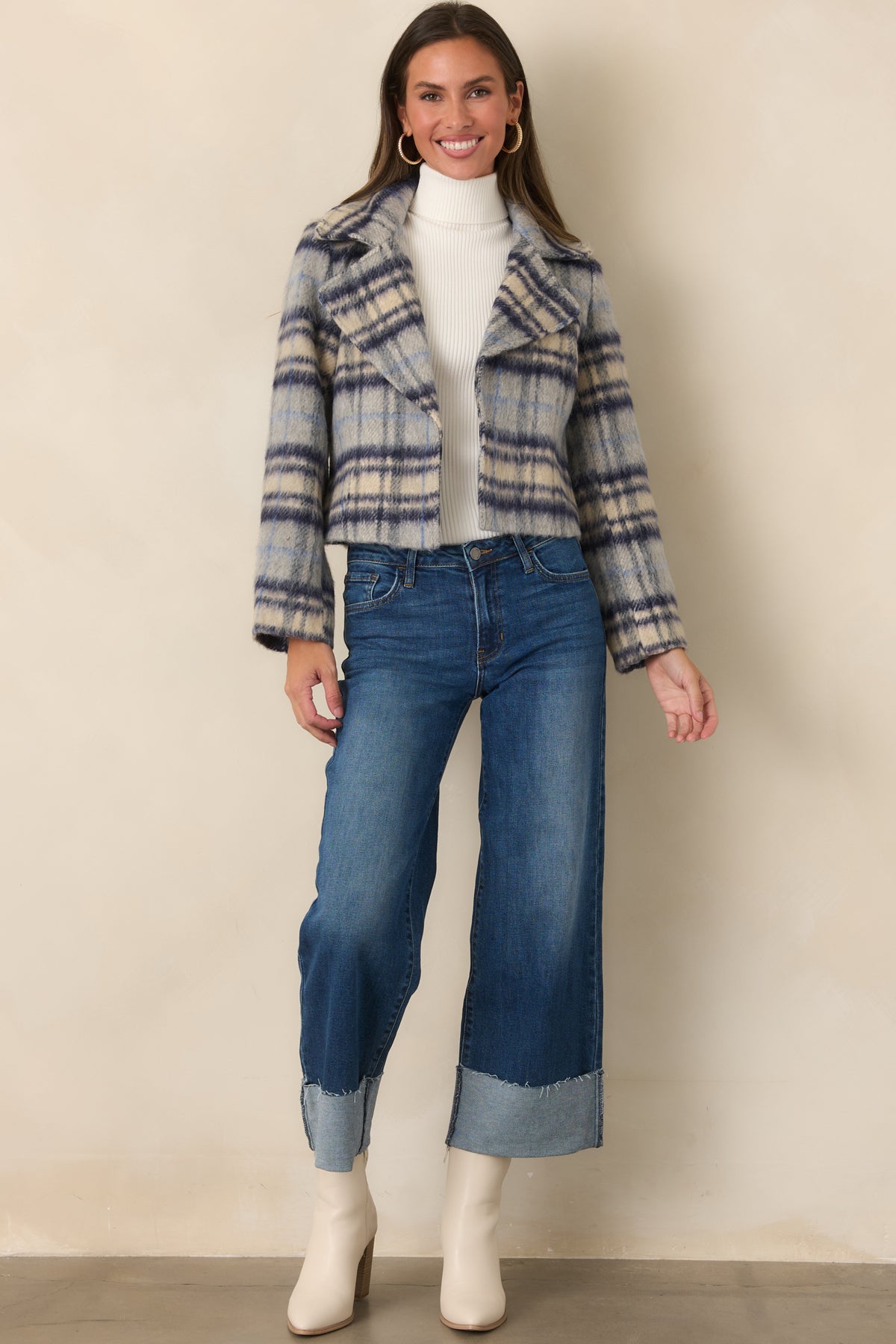 Wide-leg dark wash jeans showcasing classic five-pocket styling and bold turned cuffs.