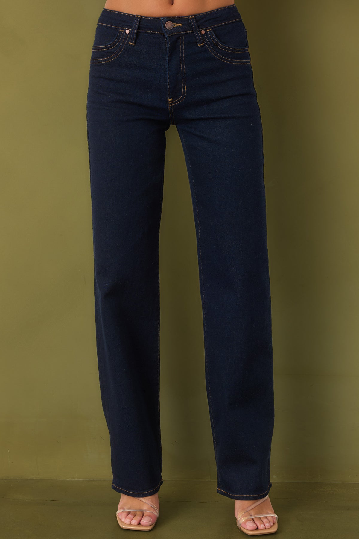 Wide-leg jeans featuring distinctive double-row stitching along the front pockets on olive green background.