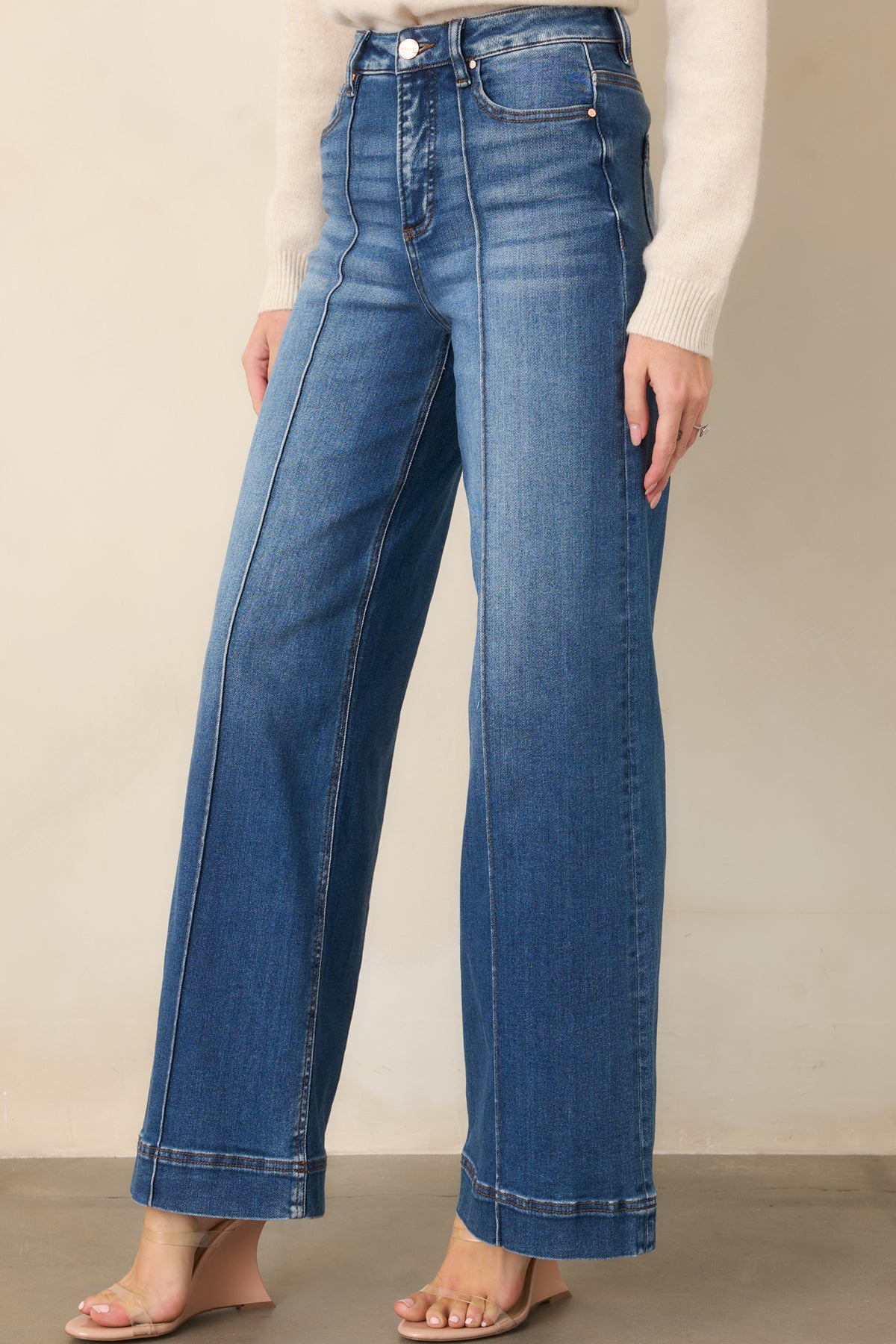 Wide-leg jeans featuring subtle fading and whiskering throughout the denim.