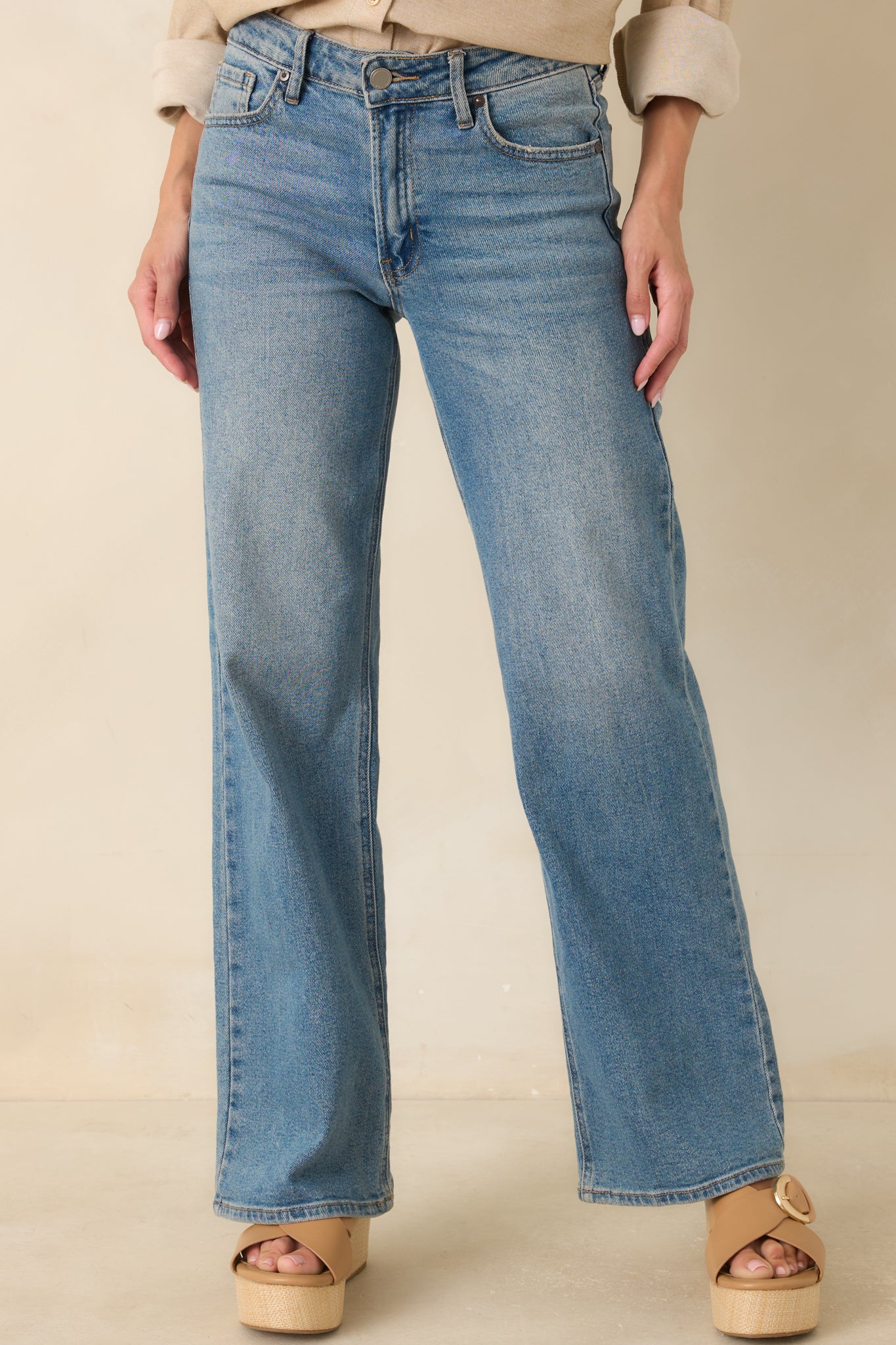 Close-up of the wide leg jeans highlighting the medium wash denim and clean front pocket detailing.