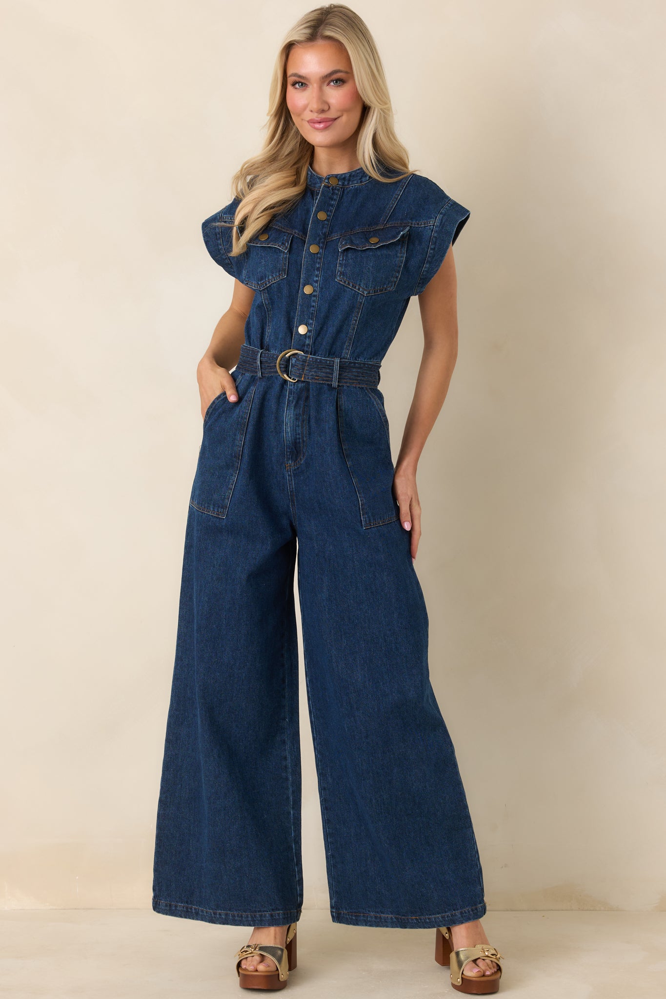 Wide-leg jumpsuit featuring a removable self-tie belt with metal buckle and functional side pockets.