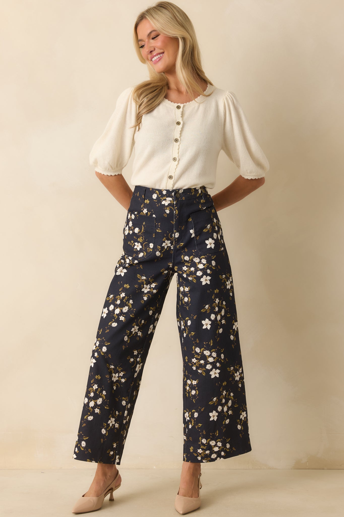 Wide leg navy jeans decorated with an allover floral design in ivory and olive, finished with a high rise waist.
