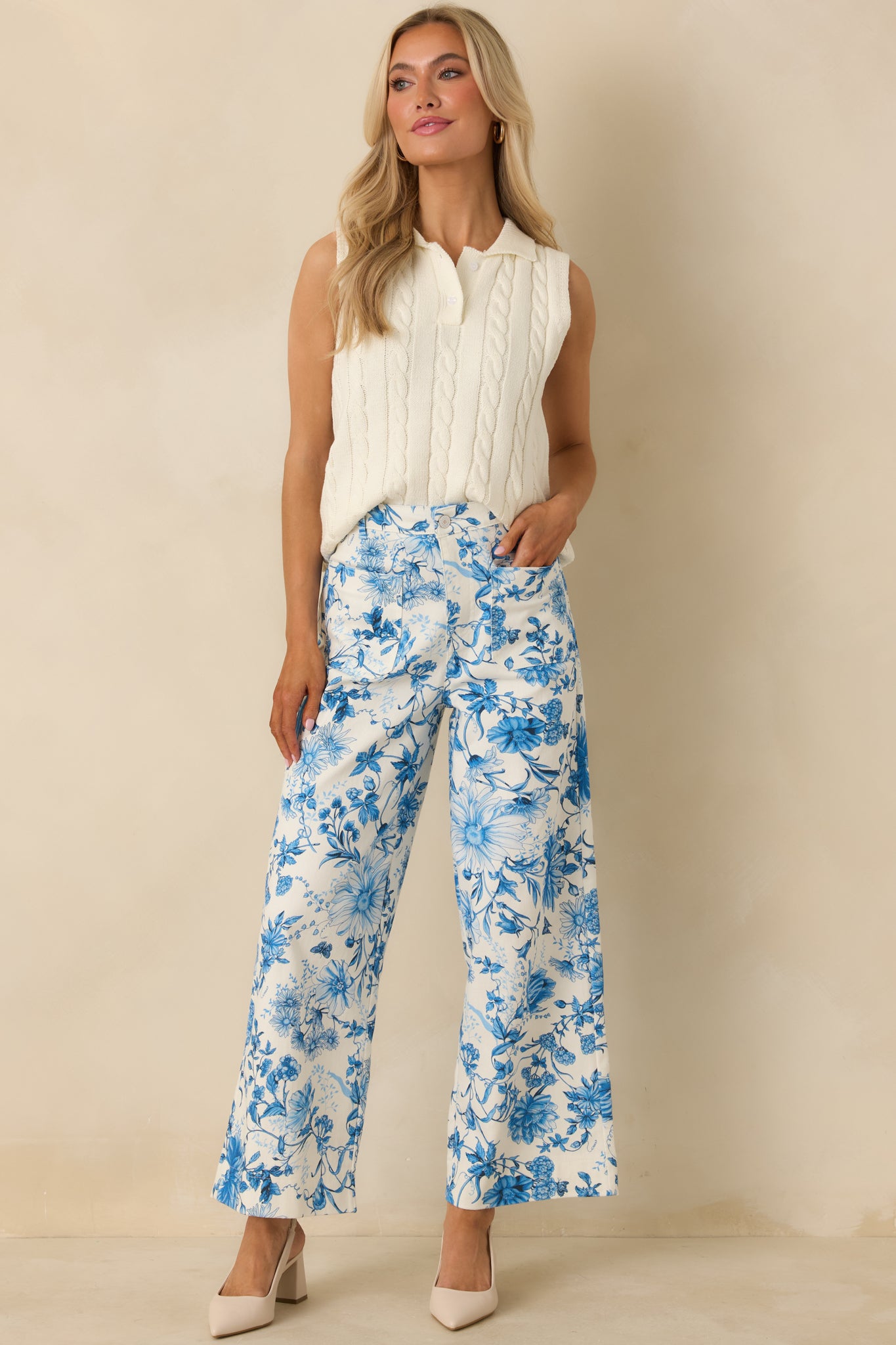 High-waist wide-leg pants featuring allover blue floral print, belt loops, and breathable cotton fabric.