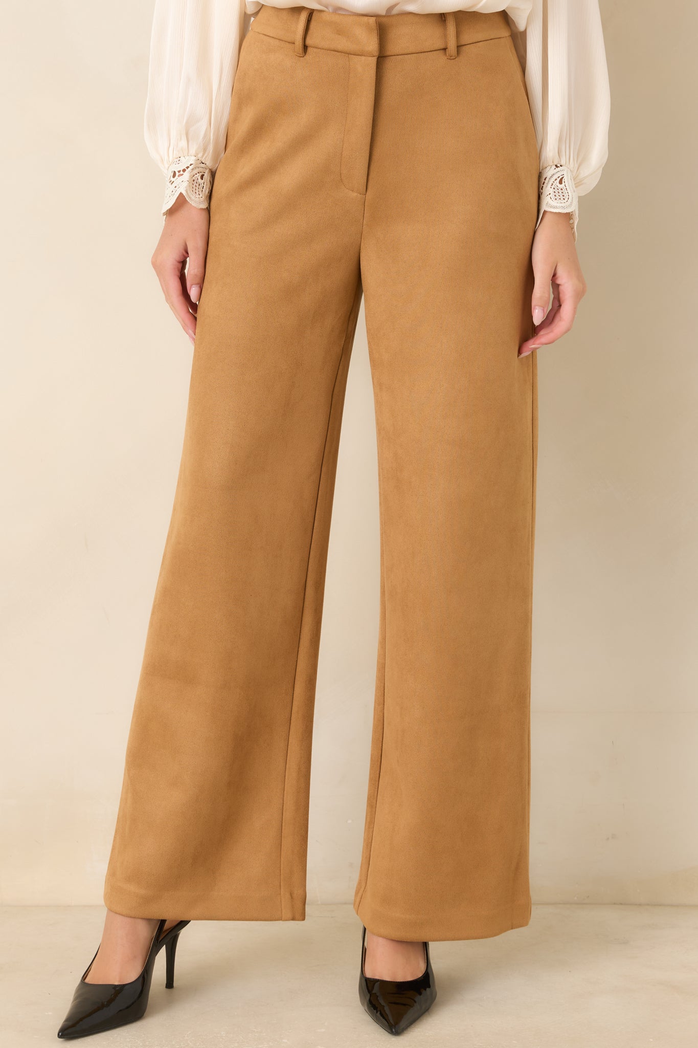 Detailed view of the wide-leg pants featuring the smooth front construction, tailored finish, and practical side pockets.