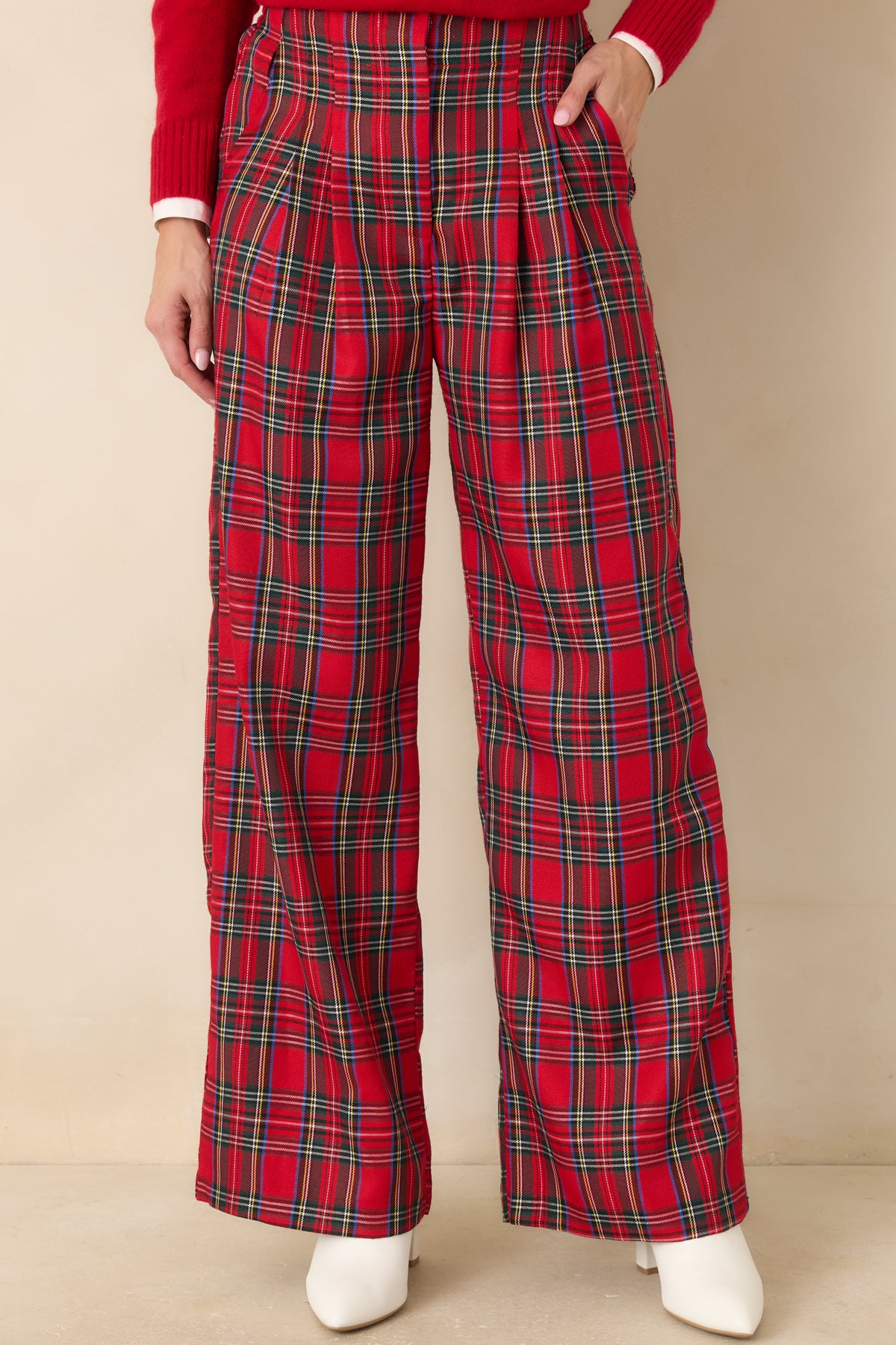 Wide-leg red tartan pants showcasing the bold plaid pattern and crisp pleated detailing.
