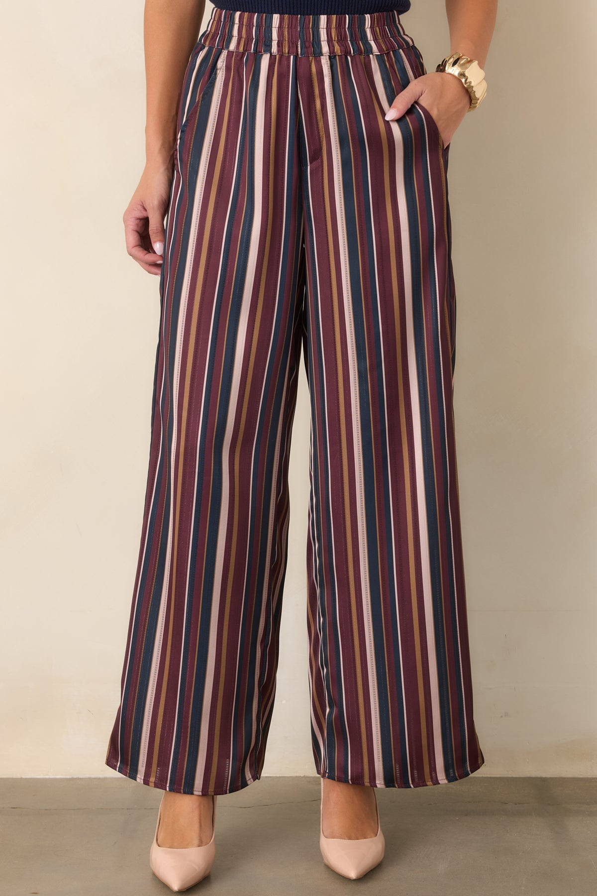 Wide leg satin pants showcasing the smooth fabric and flowing drape.