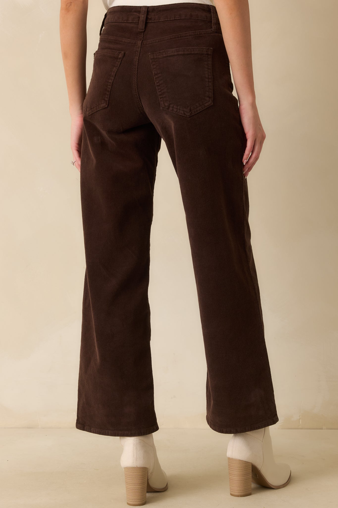 Back view showing the functional back pockets, belt loops, and wide-leg silhouette.