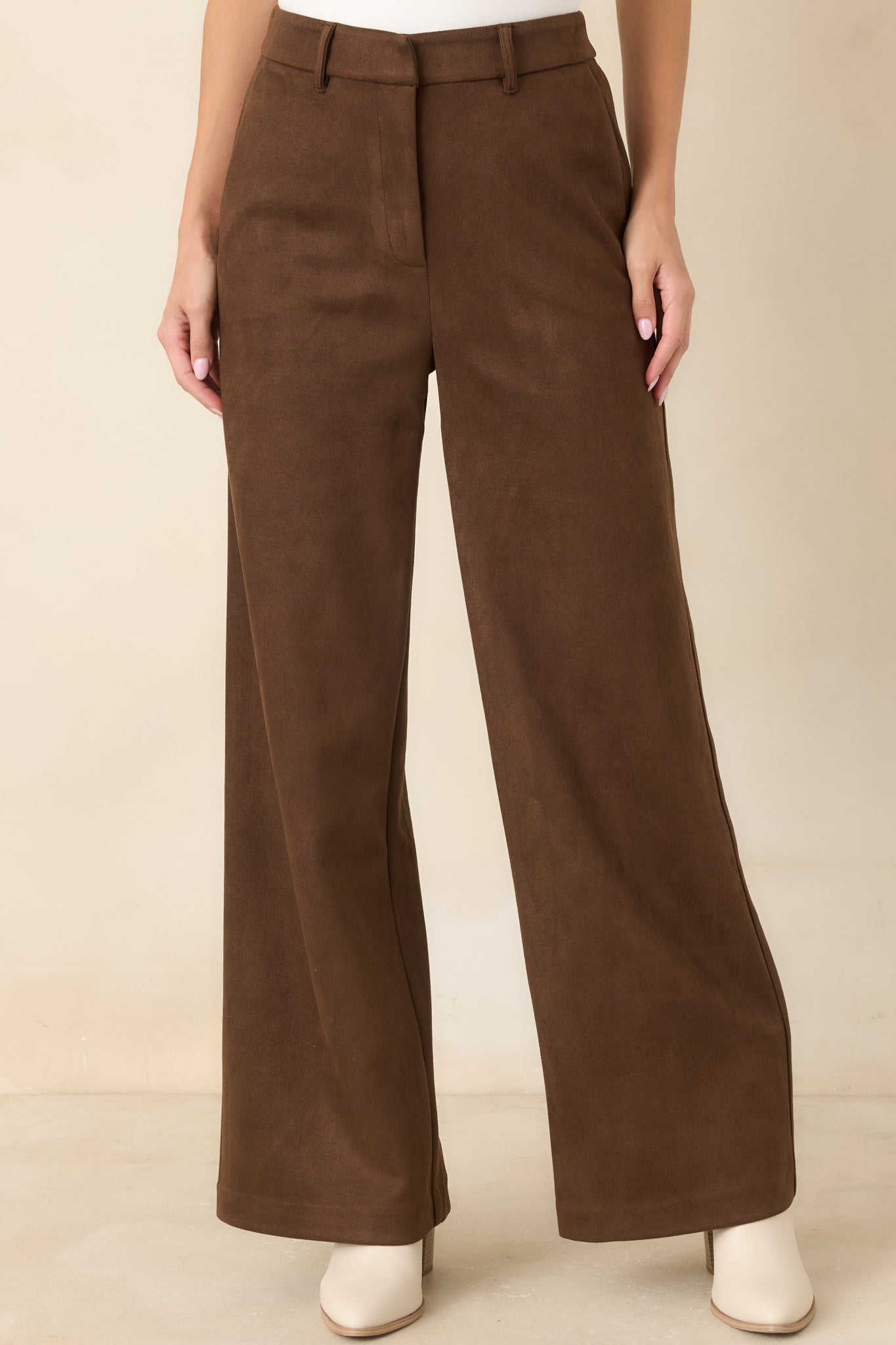 Detailed view of the pants showcasing the practical side pocket, belt loop, and smooth polished fabric construction.