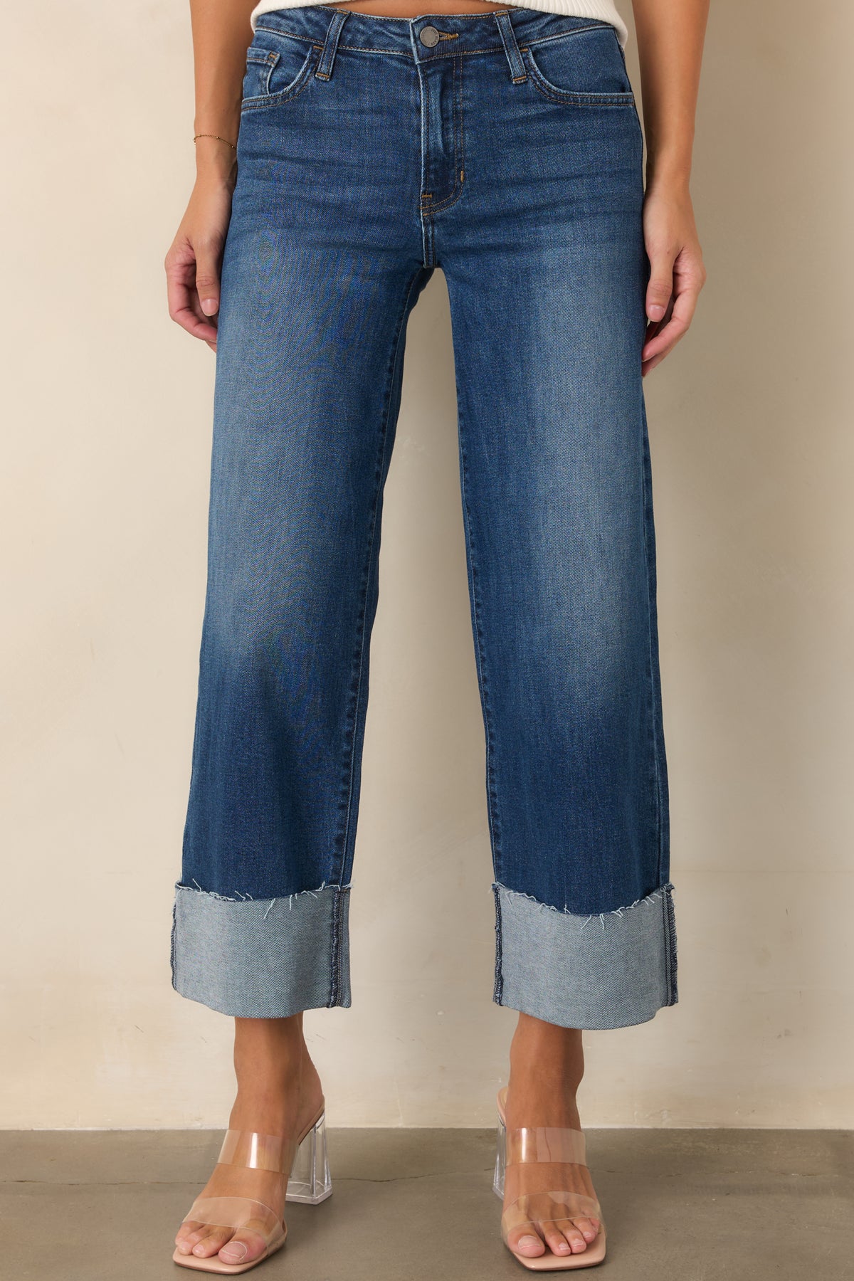 Wide-leg stretch denim jeans with subtle fading and a structured waistband.