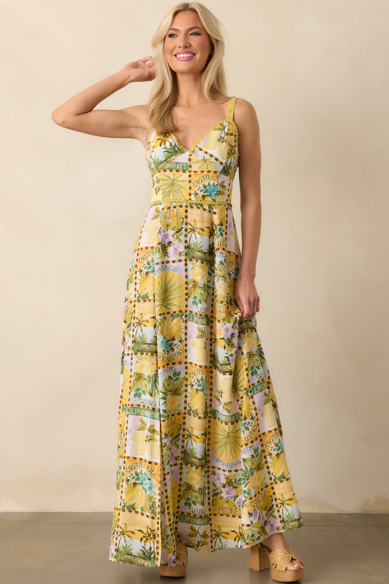 Wide view of the dress featuring the v-neckline, fitted bodice, and flowing hemline in the tropical pattern.