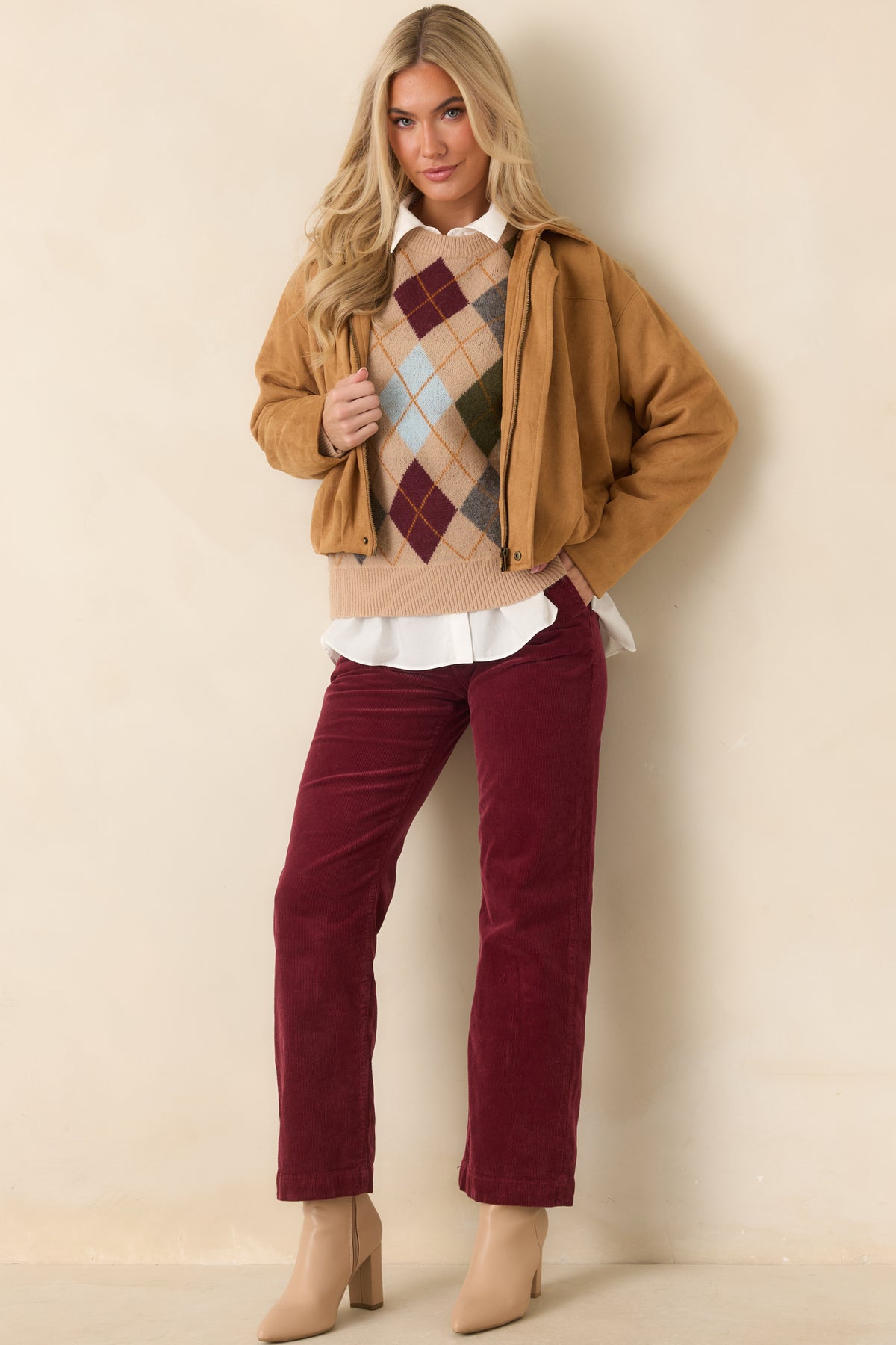 Rich wine corduroy trousers featuring a relaxed straight-leg fit and a clean, structured shape.