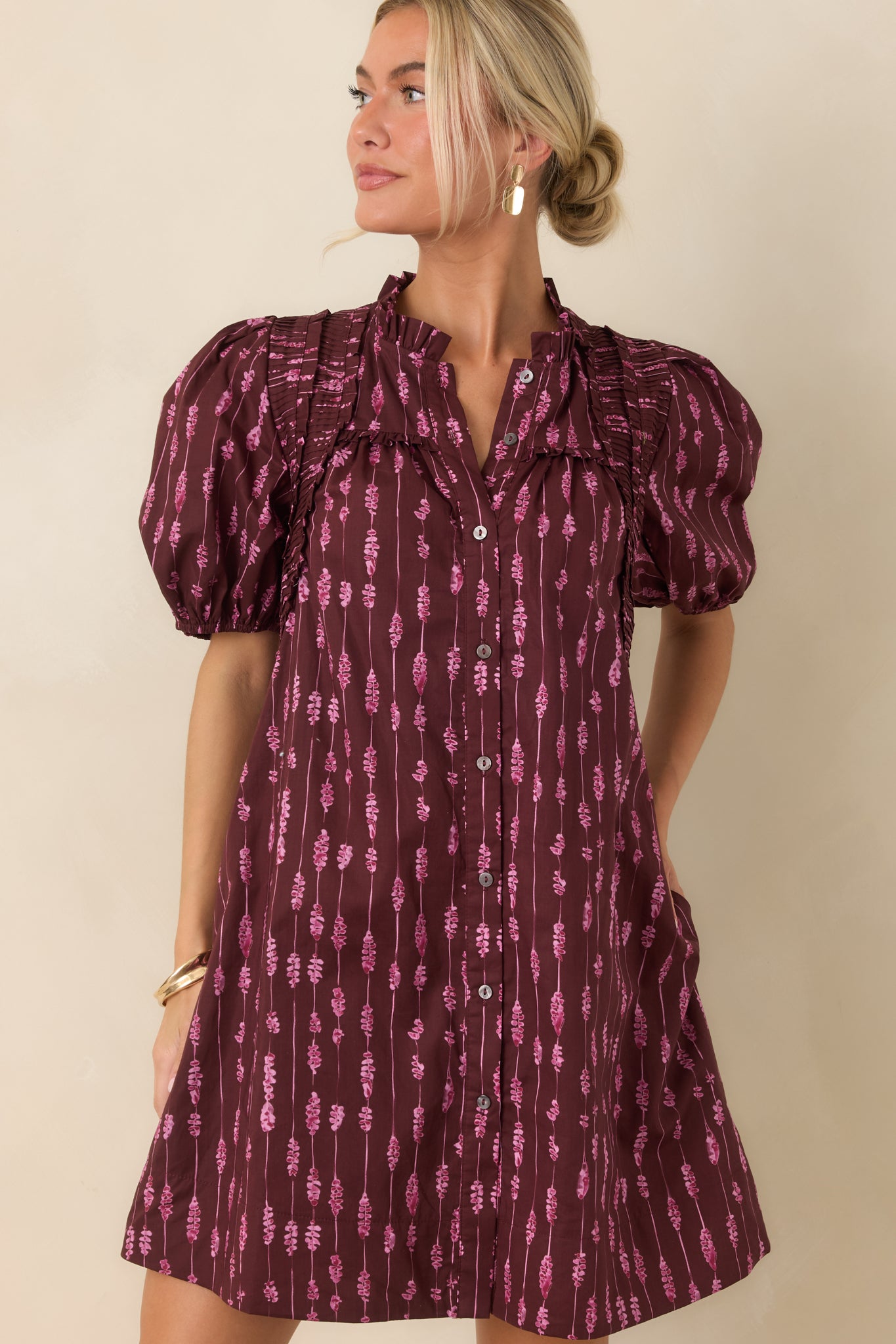Wine cotton mini dress featuring a bold pink abstract stripe print and softly gathered sleeve detailing.