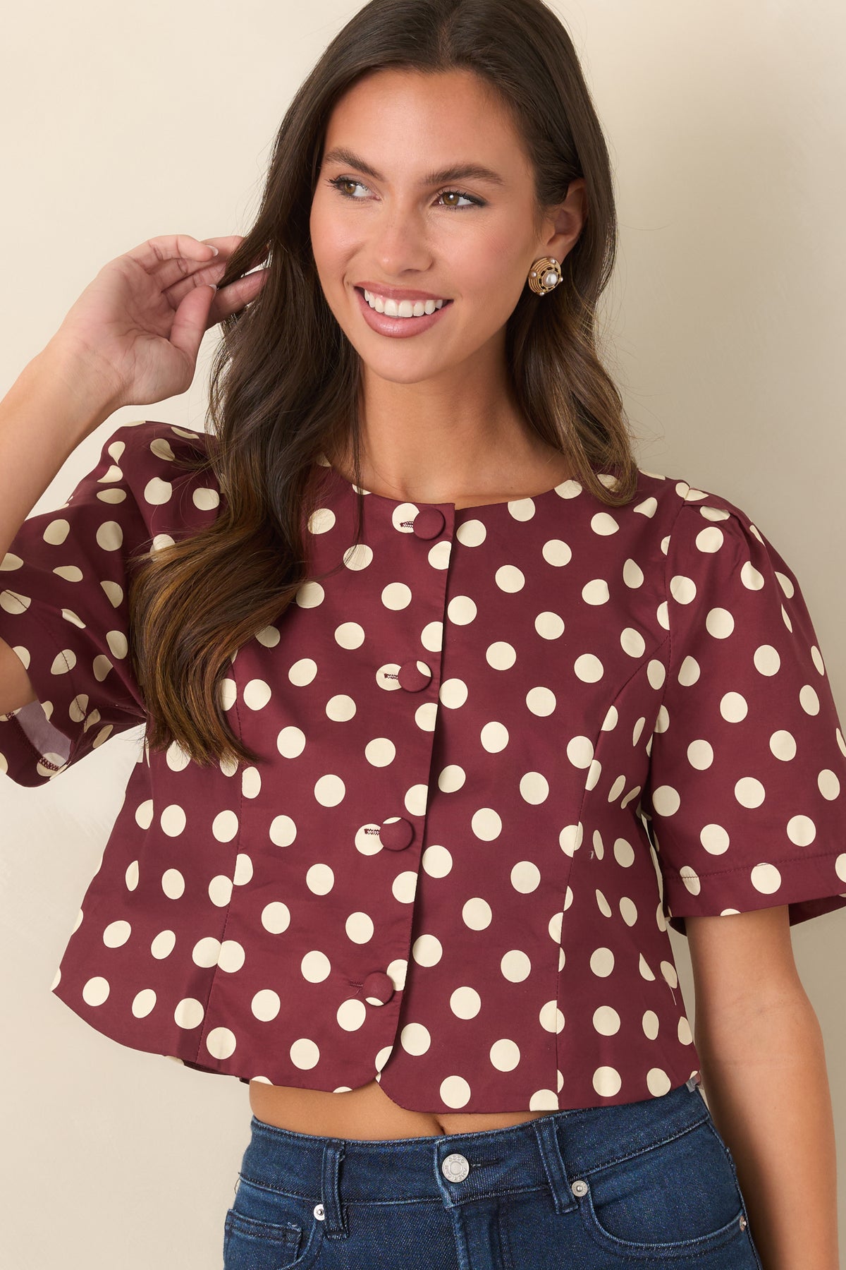 Rich wine cropped top showcasing fabric-covered front buttons and gathered short sleeves.