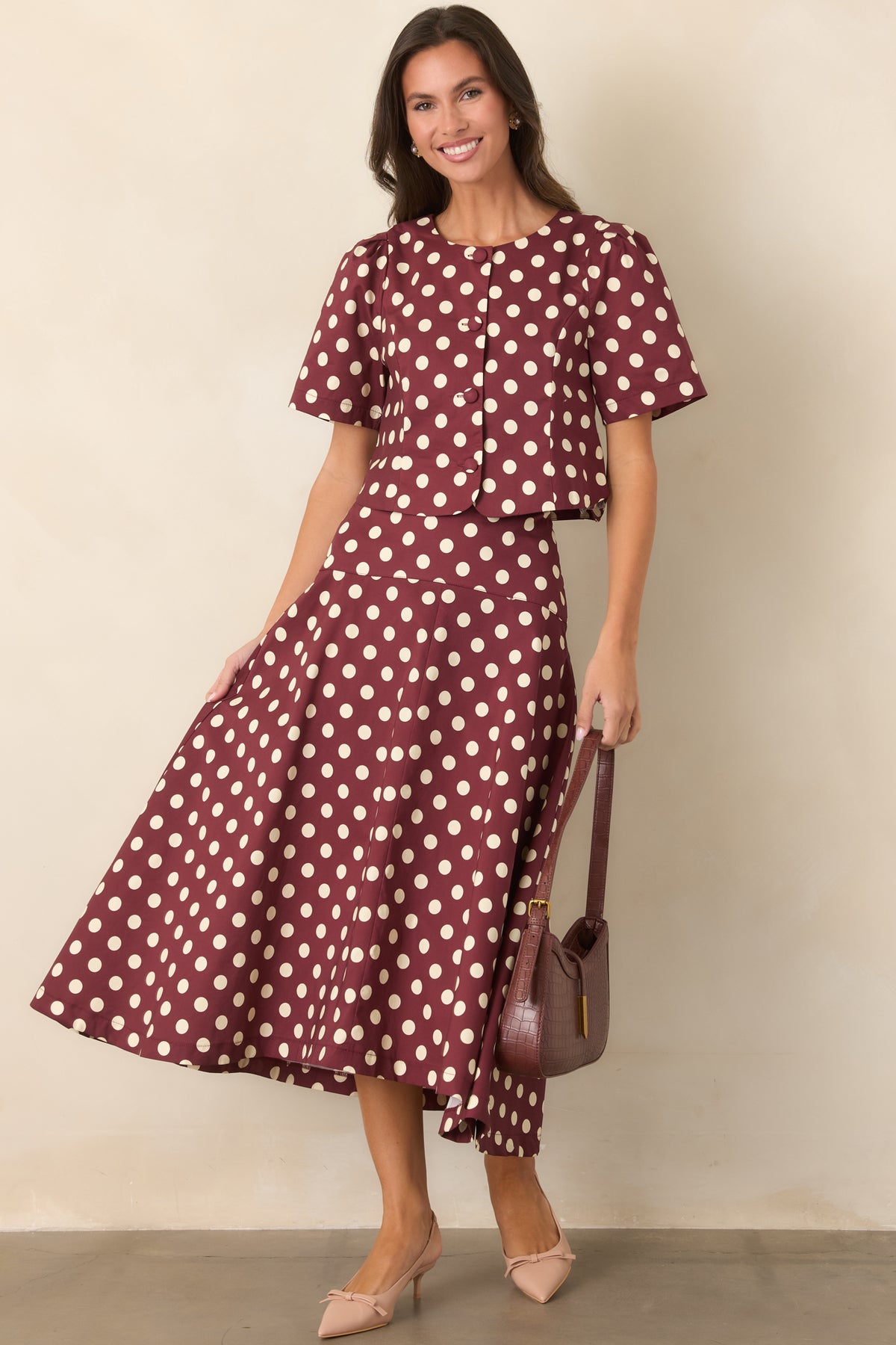 Wine cotton cropped top featuring an ivory polka dot print and fabric-covered front buttons.