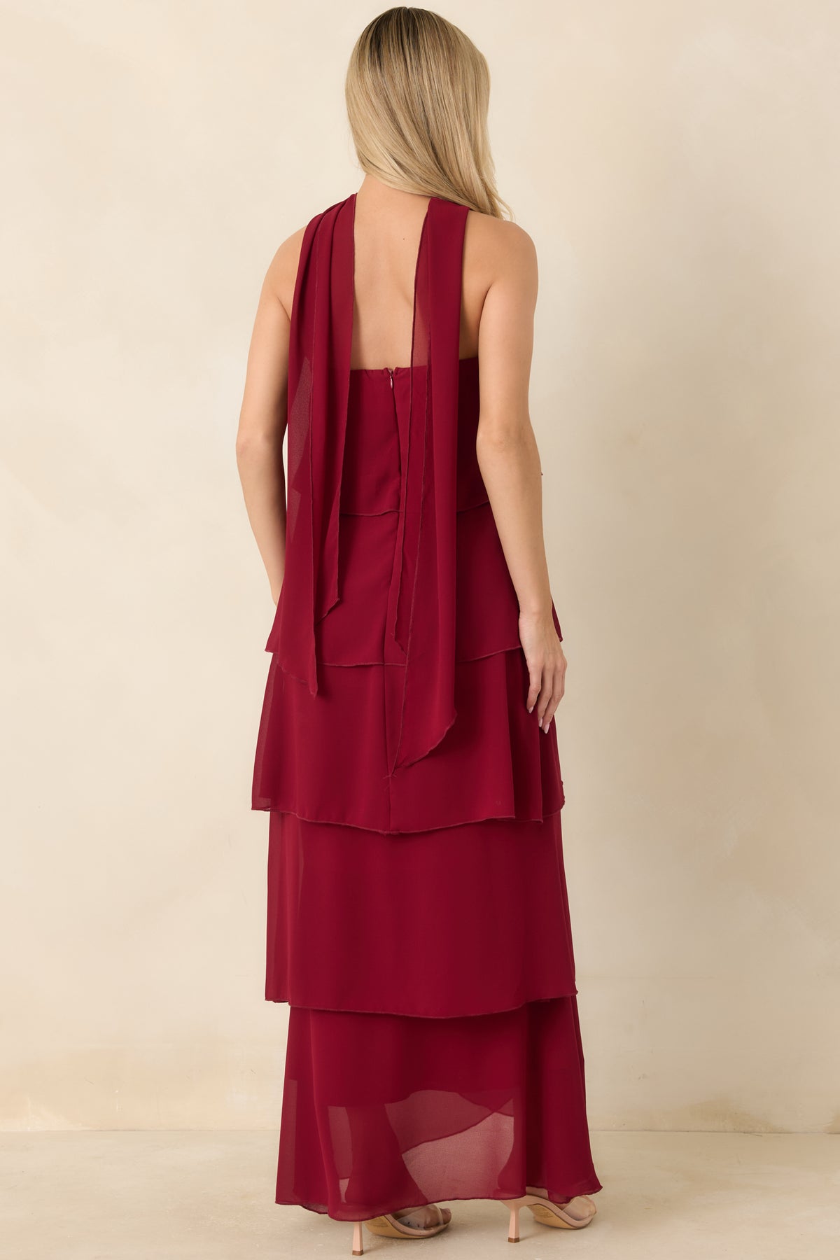 Rear view of the wine red dress showing the concealed zipper and cascading angled ruffles.