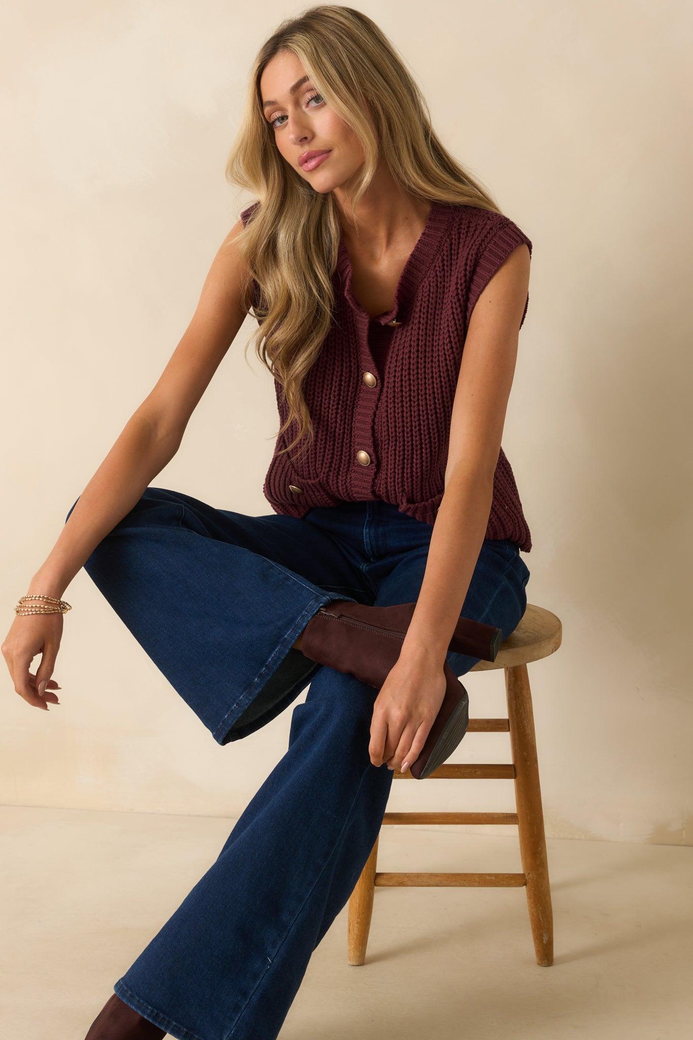 Wine red sweater vest with ribbed knit fabric, button-up front, and casual relaxed fit.