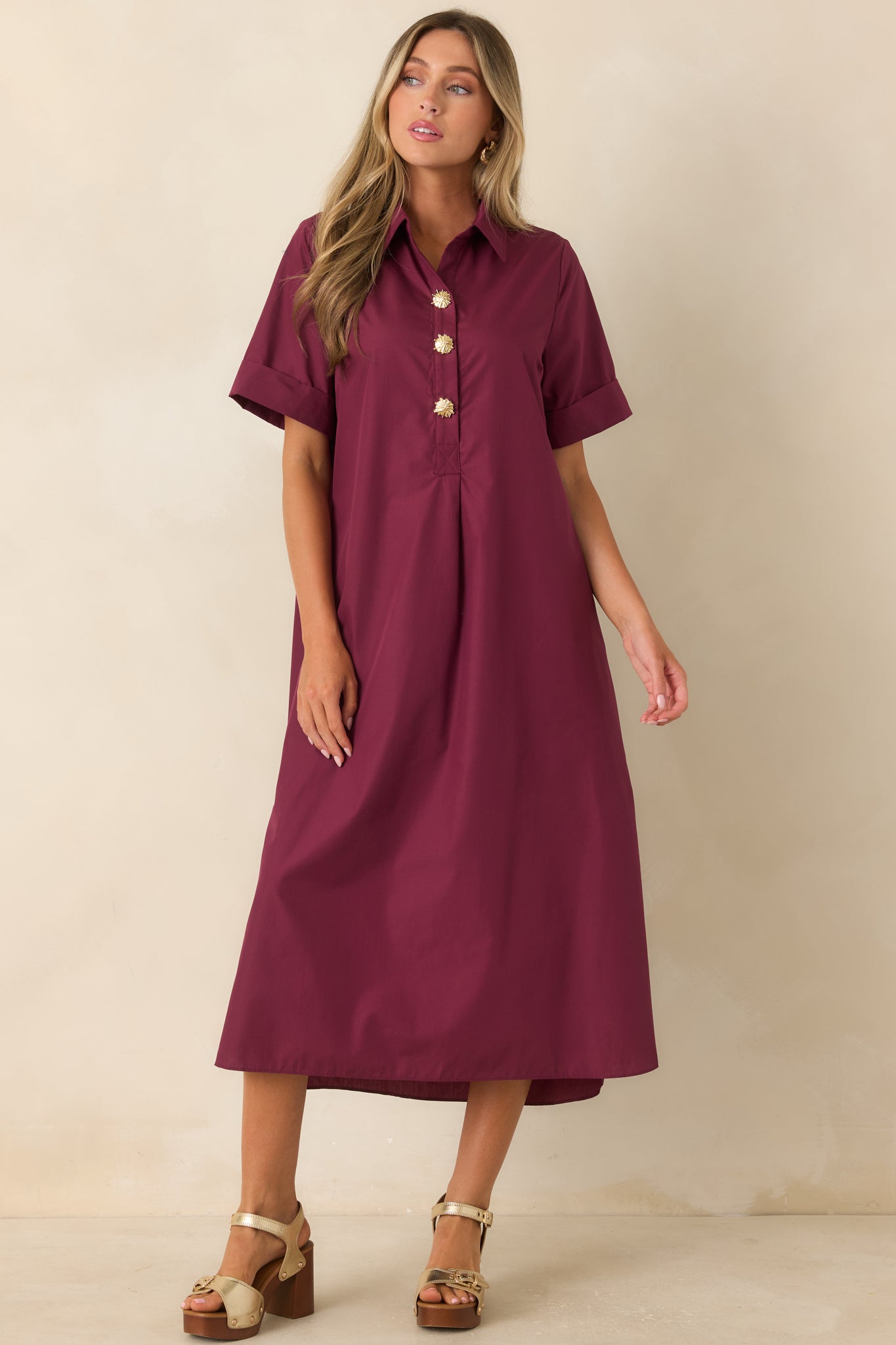 Wine red woven dress designed with a timeless shirt dress shape, side slits, and a flowing maxi length.