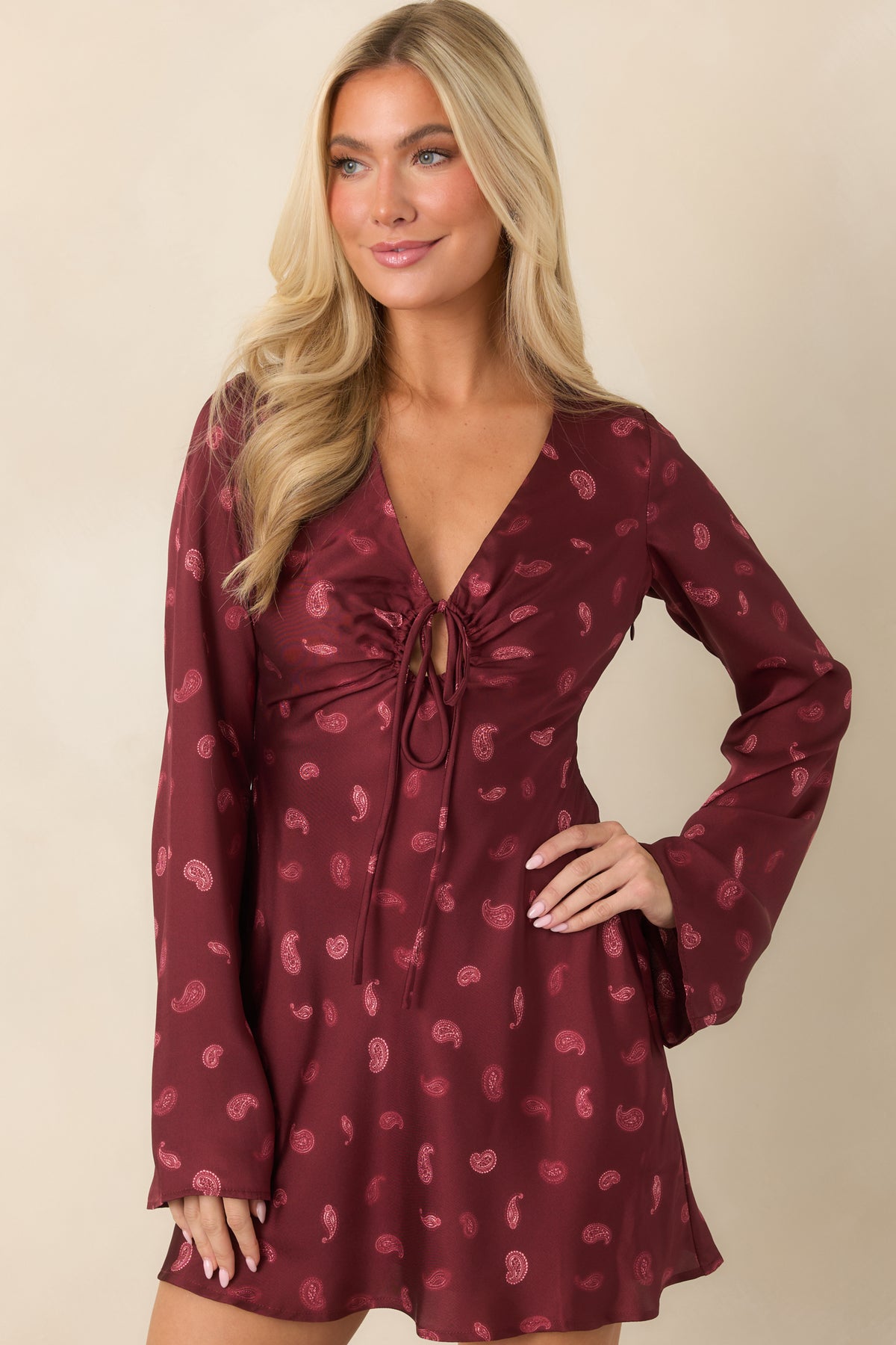 Wine satin dress highlighting the gently flared skirt and bias-cut shape.