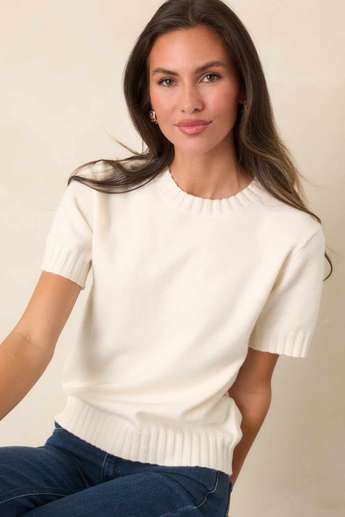 Wool-blend knit top with a clean crew neckline, short sleeves, and subtle ribbed trim framing the silhouette.