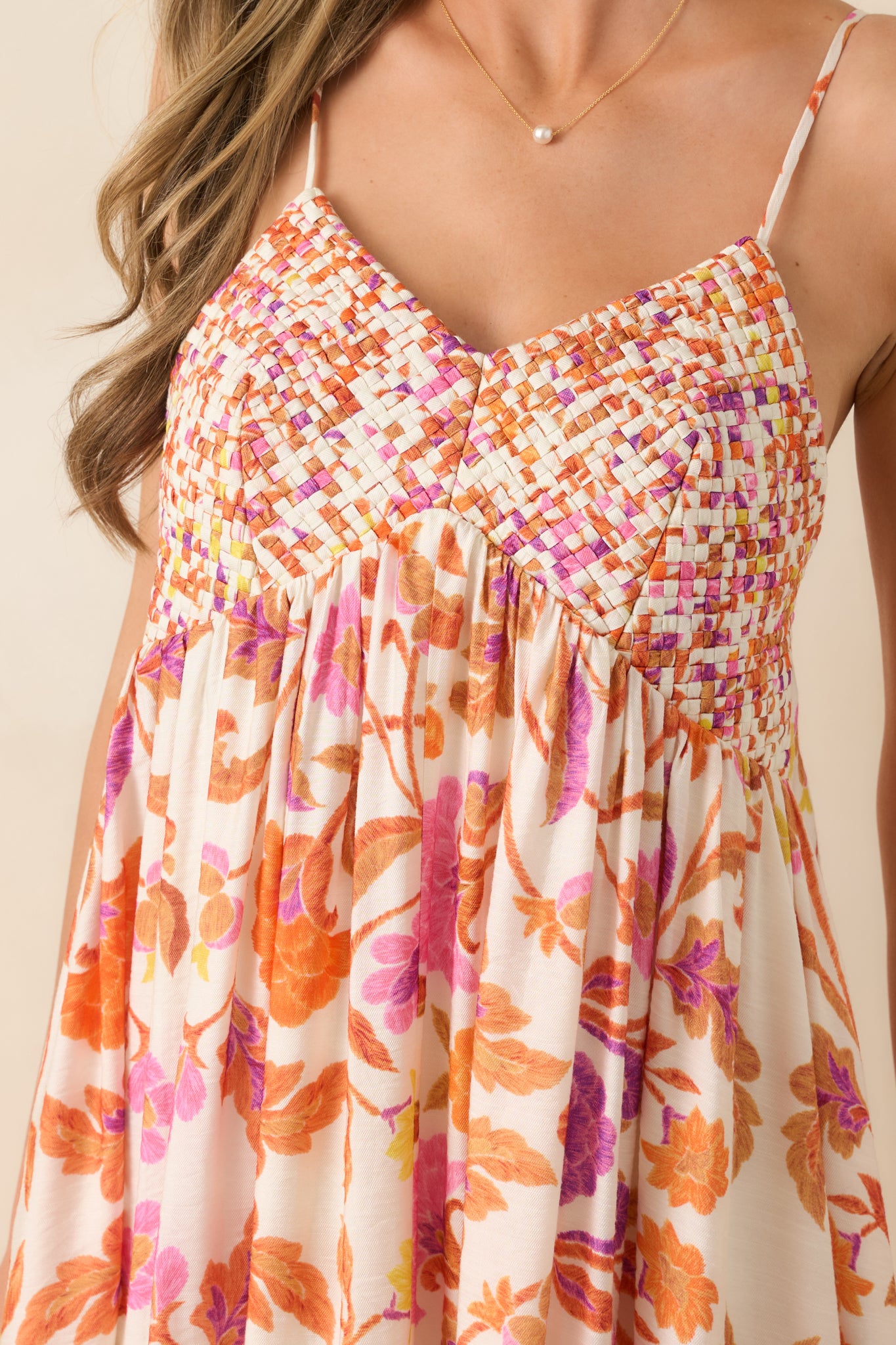 Woven bust detail with textured construction and gathered fabric transition below.