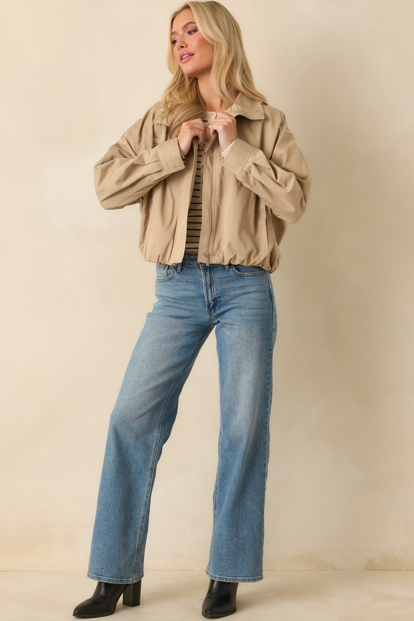 Woven shell jacket in khaki showcasing elasticized back hem and functional welt pockets.