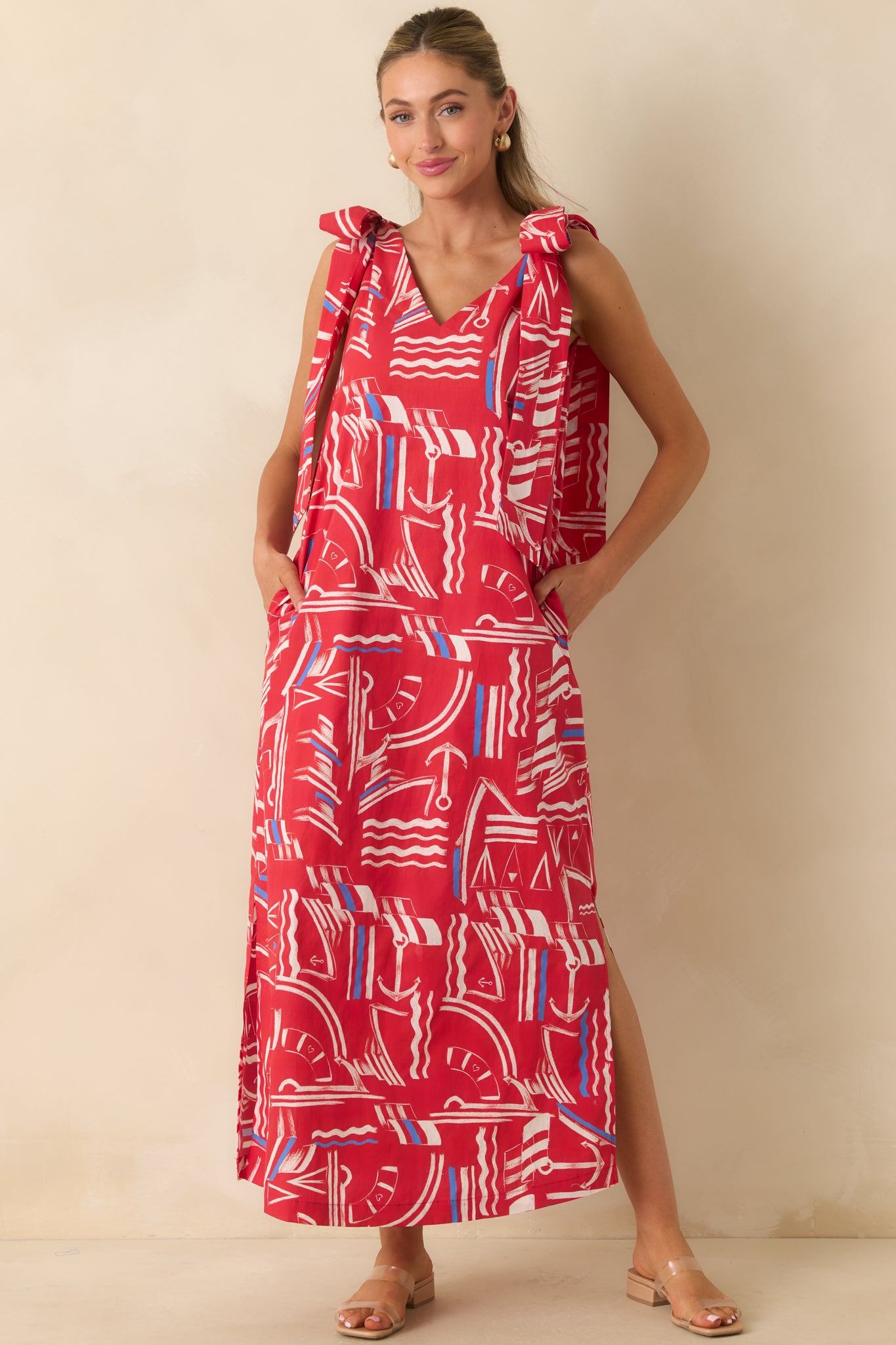 Lightweight cotton maxi dress featuring a V-neckline, wide shoulder straps, oversized self-tie bows, yacht club print, and flowy silhouette.