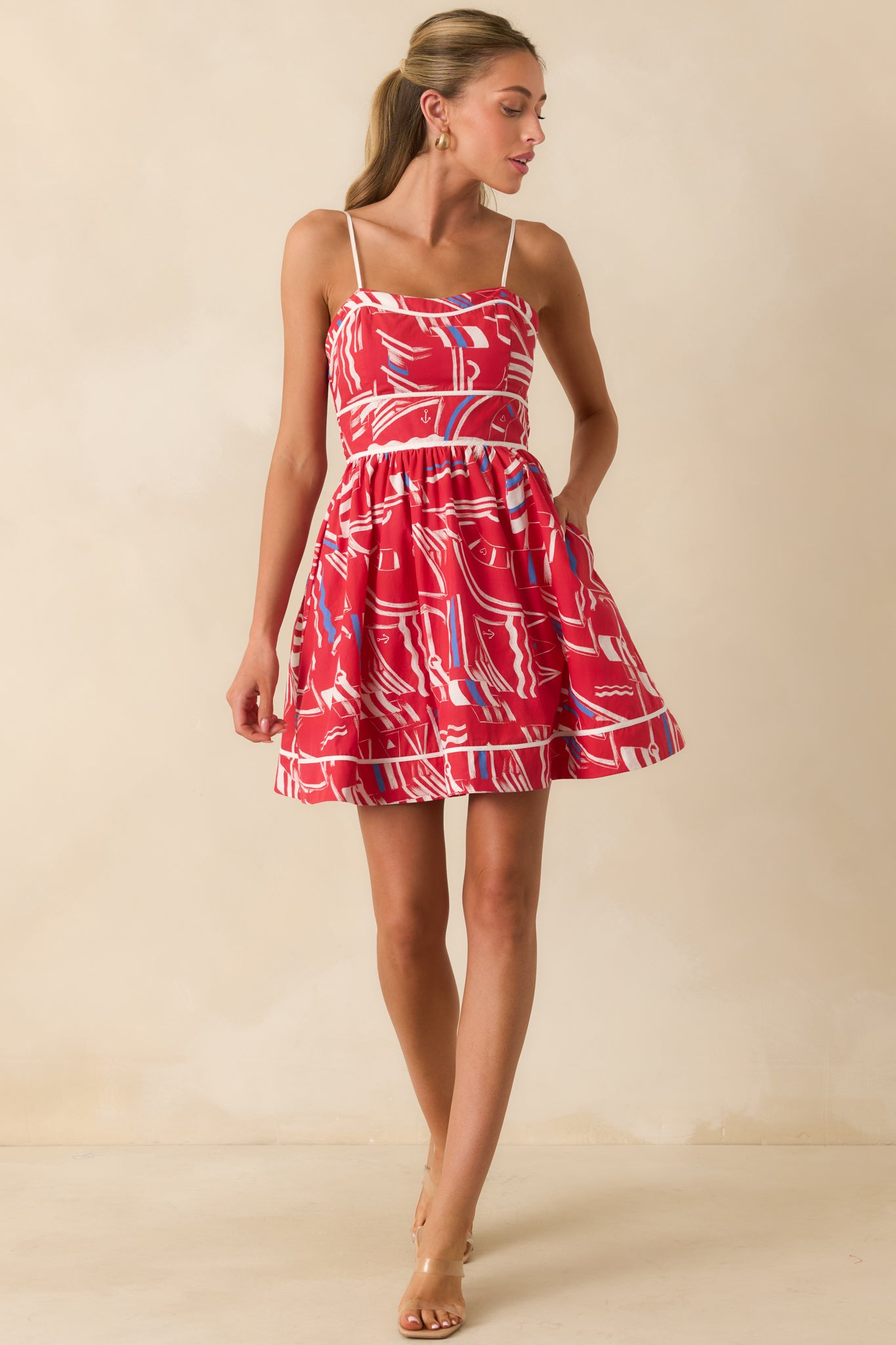 Close-up of the vibrant yacht club print and gathered skirt detailing on the cotton mini dress.