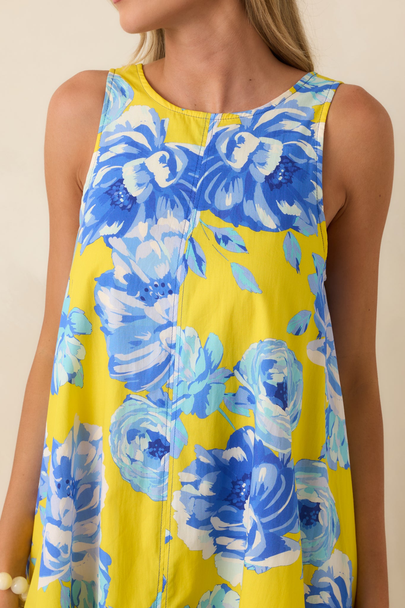 Close-up of the yellow and blue floral print on the lightweight 100% cotton fabric, showing texture and color detail.