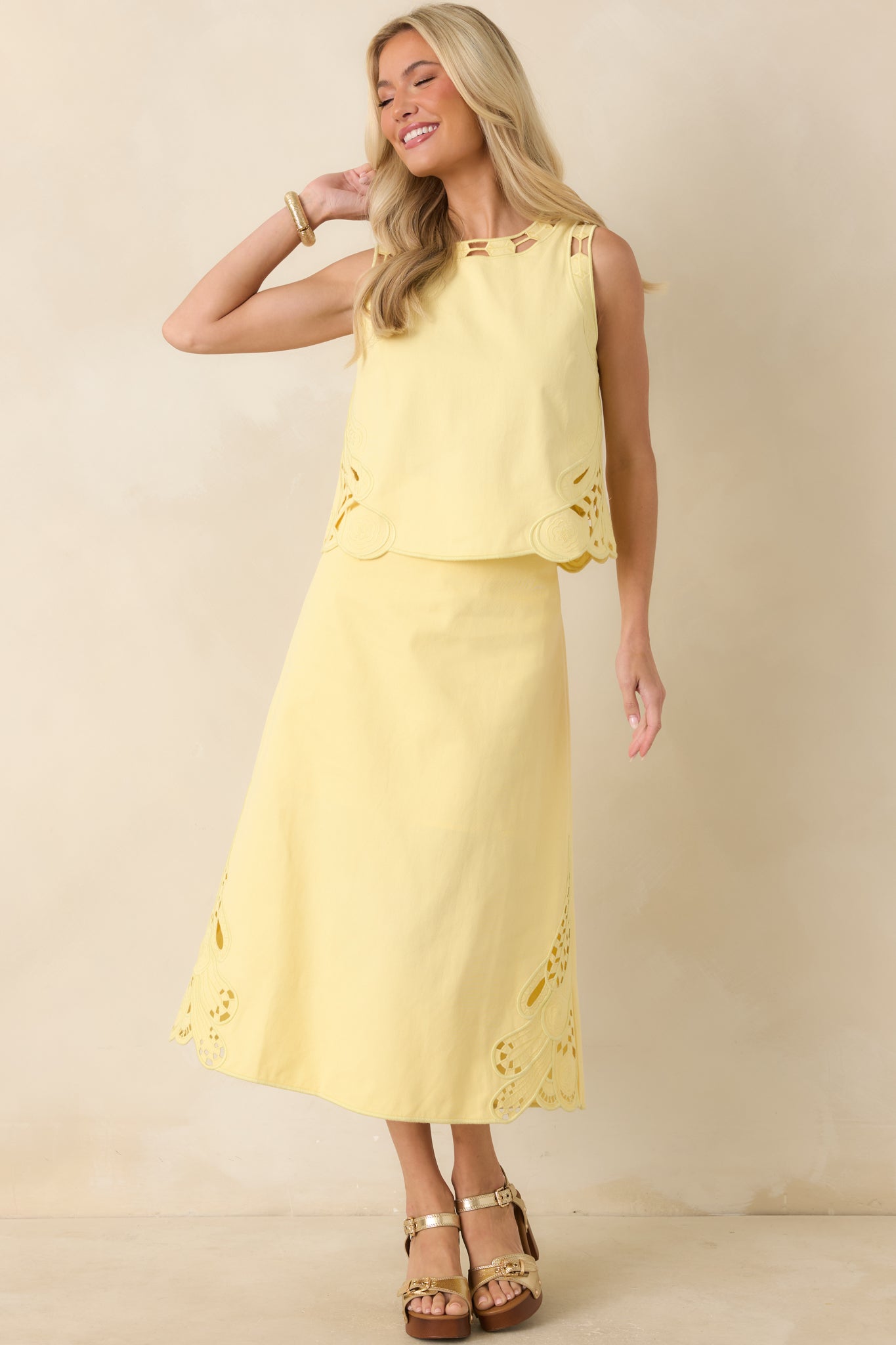 Tailored cotton midi skirt in yellow with a smooth waistband, structured drape, and elegant A-line shape.