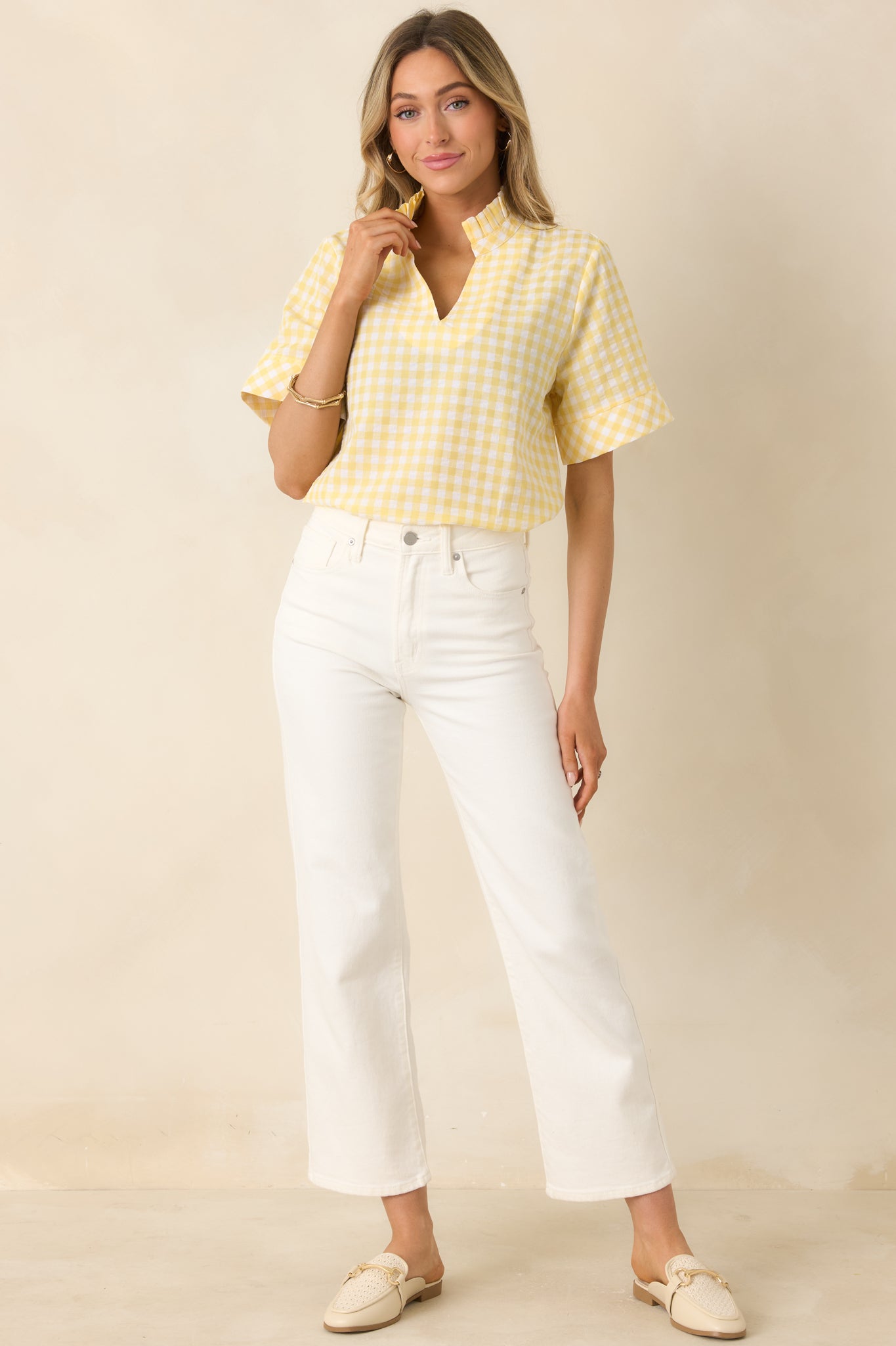 Yellow gingham top with classic check pattern, collared neckline, and split V-neck.