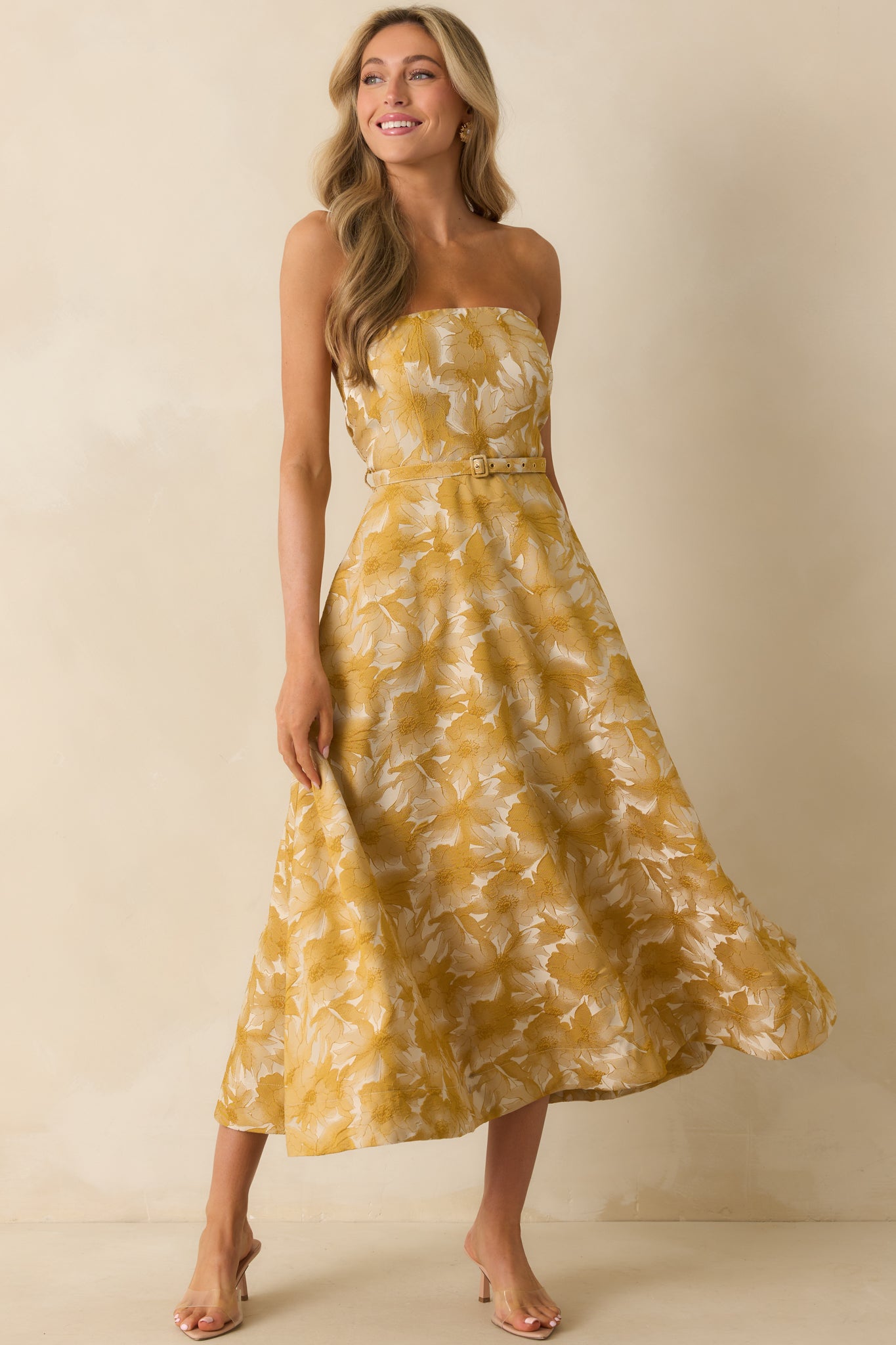 Yellow gold midi dress with strapless neckline and fitted bodice.