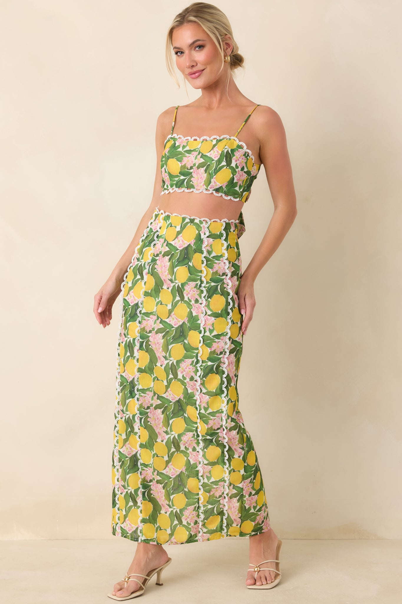 Yellow high-rise maxi skirt with an allover lemon blossom print, fitted waistband, and straight, elongating silhouette for a polished warm-weather look.