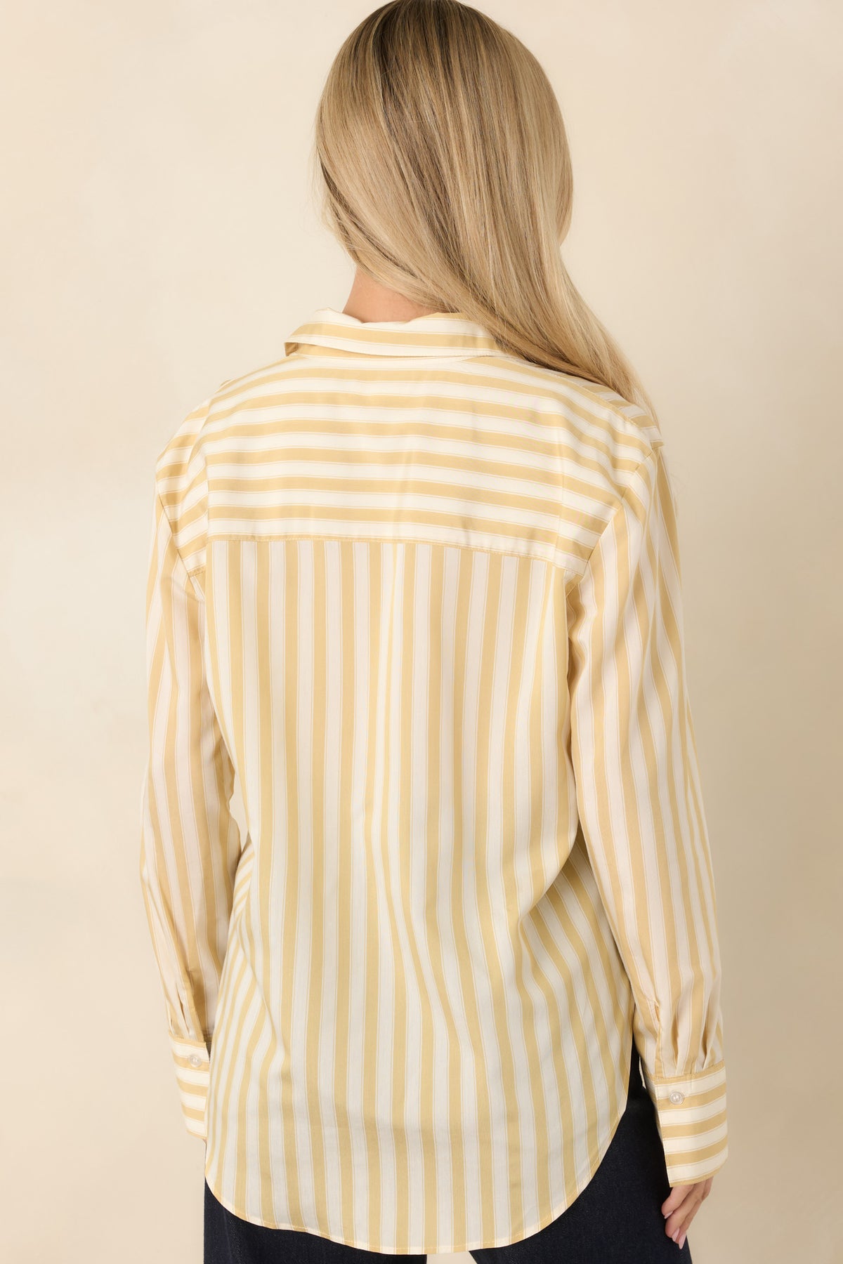 Back view of yellow and ivory striped button-down shirt featuring a horizontal striped back yoke, vertical stripes, and curved hem.