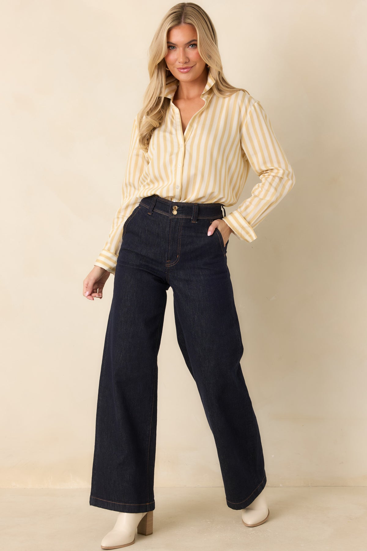 Yellow and ivory striped button-down shirt with a pointed collar, vertical stripe pattern, and long cuffed sleeves.