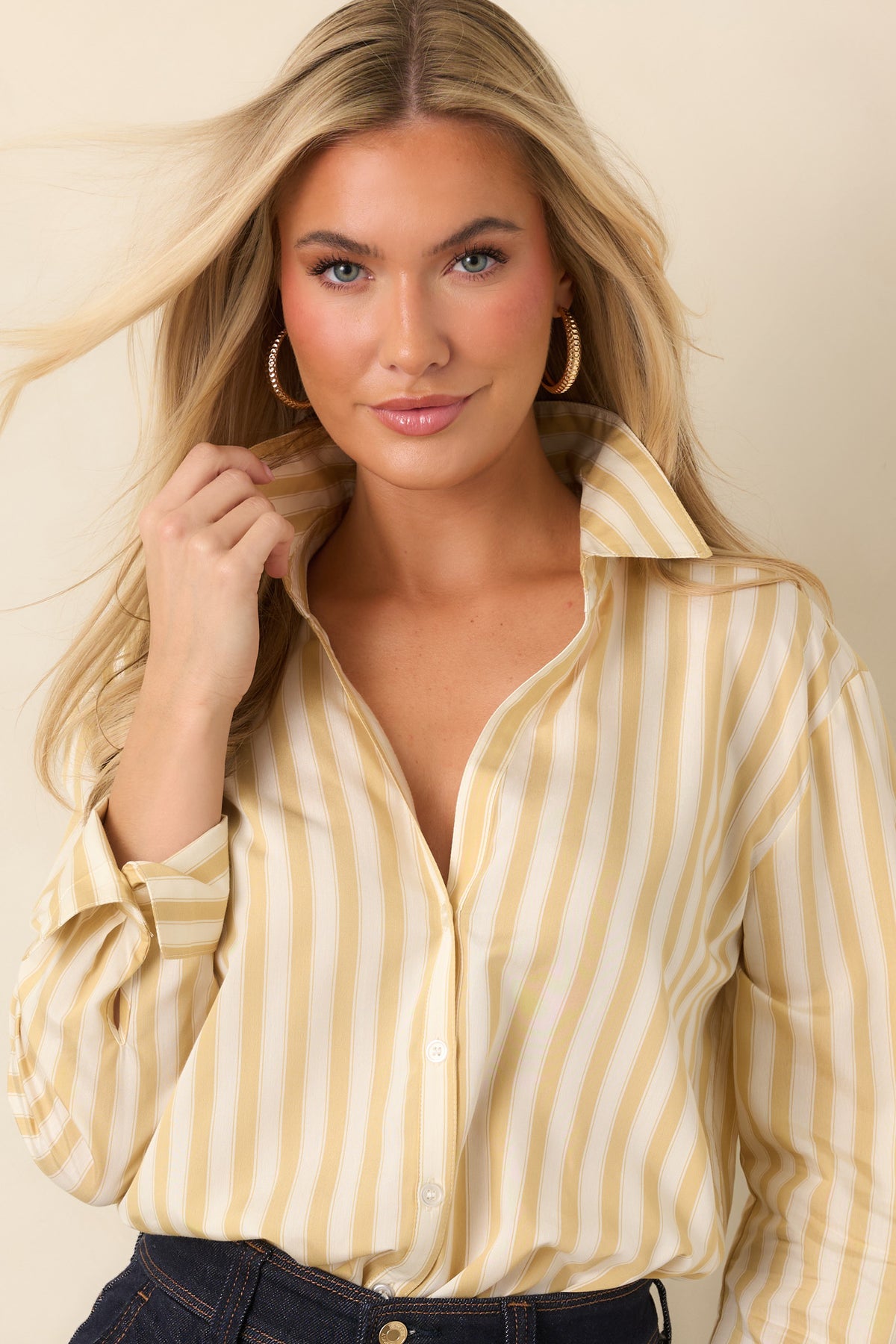 Pale yellow and ivory striped button-down shirt featuring a pointed collar, open V-neckline, and long sleeves with buttoned cuffs.