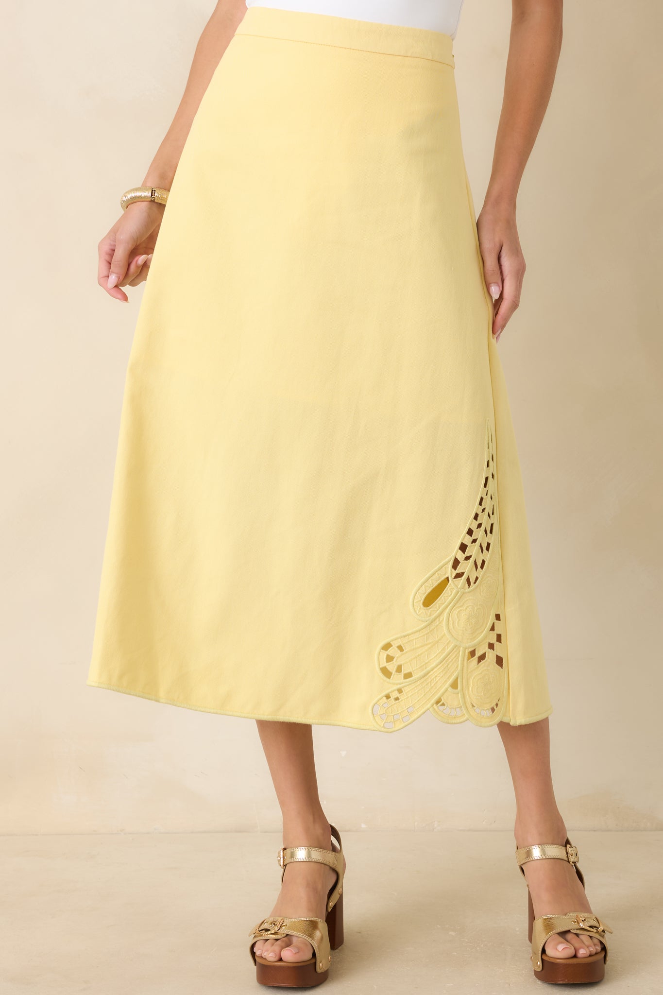 Yellow midi skirt featuring precise seam work and a polished, structured finish.