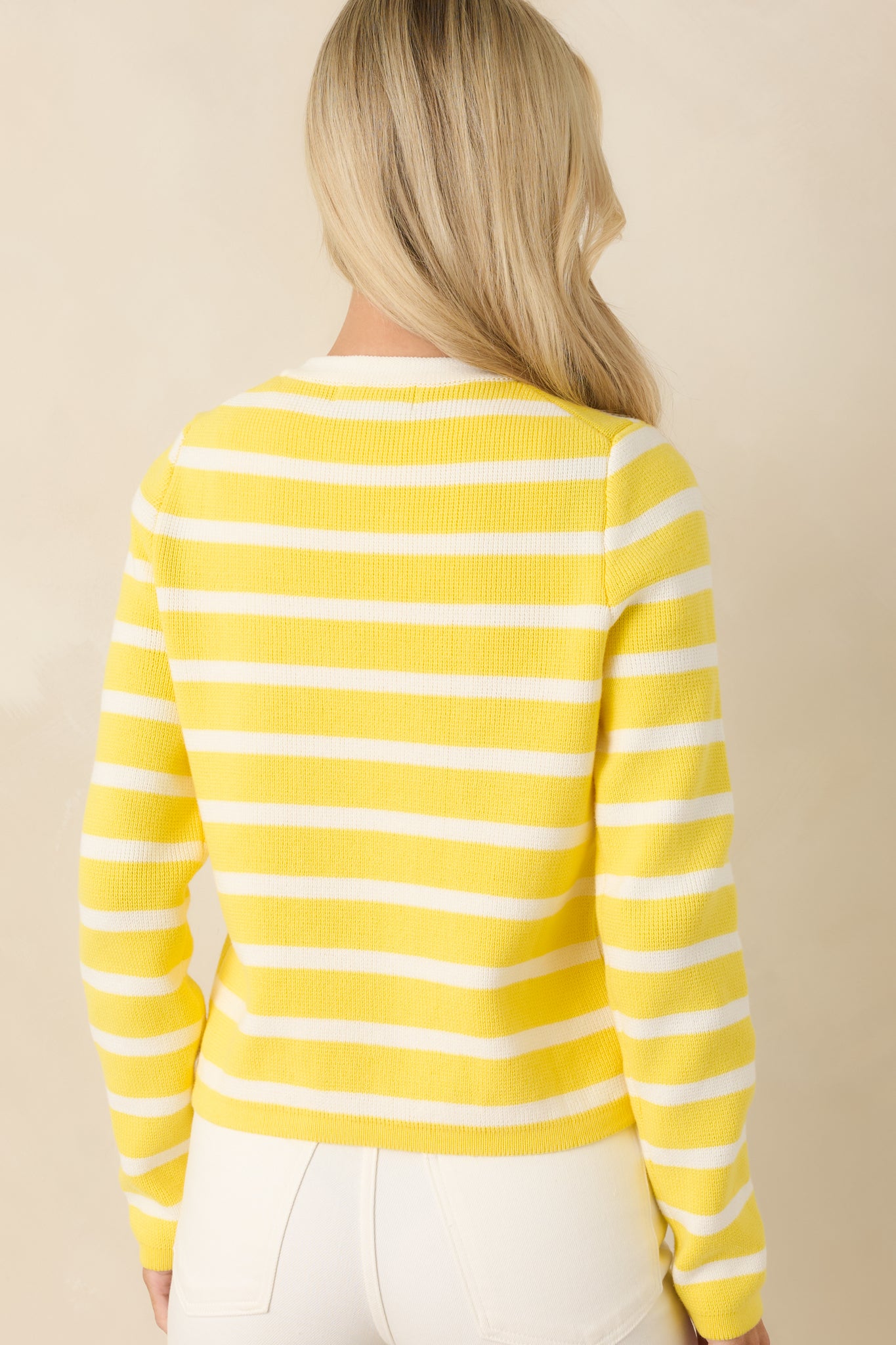 Back view of yellow striped cardigan showing long sleeves and clean tailored silhouette.