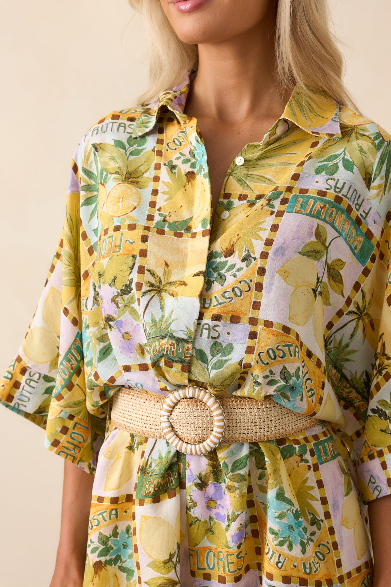 Zoomed-in image of the fabric showcasing the watercolor-style tropical fruit print and woven belt texture.