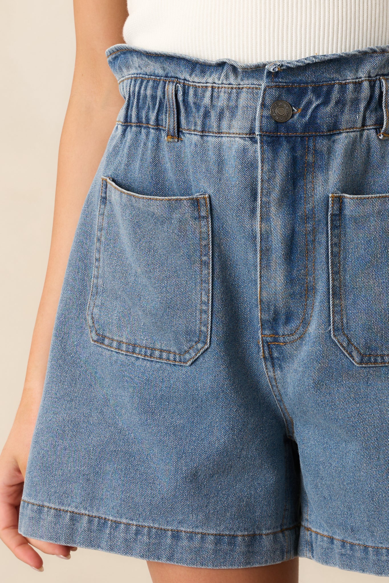 A zoomed-in look at the button-zipper closure, emphasizing the secure fastening and structured design