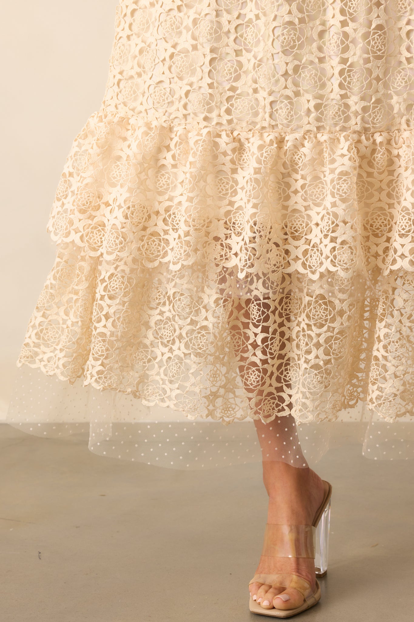 A zoomed-in shot of the lace ruffle trim along the tiered hem, highlighting stitching and polka dot lace texture.