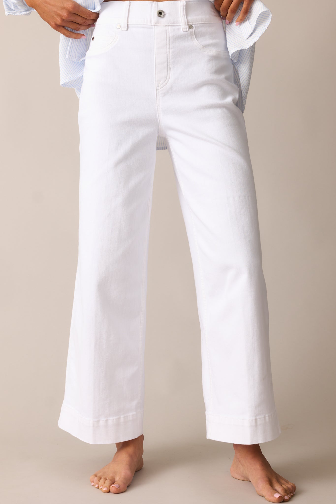 Zoomed-in shot of the upper thigh and hip area, highlighting the sculpting effect of the SPANX TummyTamer Tech™.