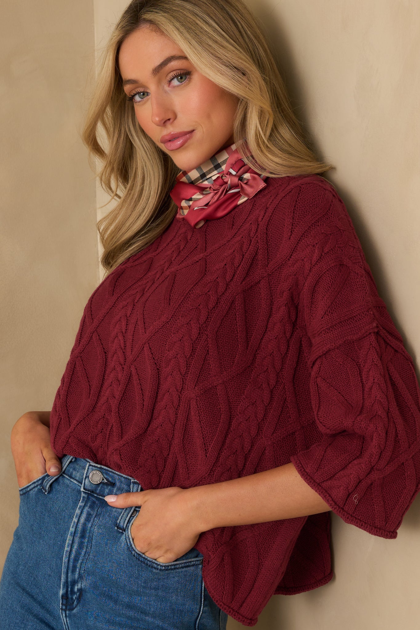 Zoomed-in view of the 3/4 sleeve, highlighting the knit texture and subtle rolled edge.