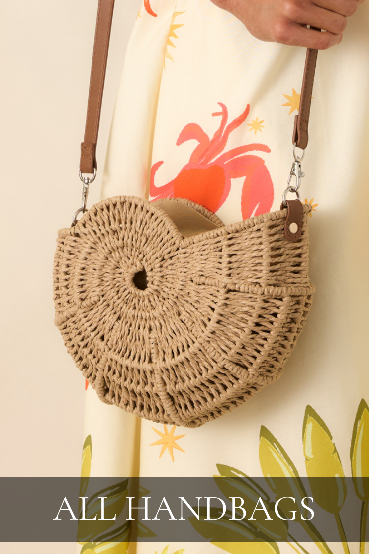 Round woven straw crossbody handbag with leather strap. Bag is featured in All Handbags collection.