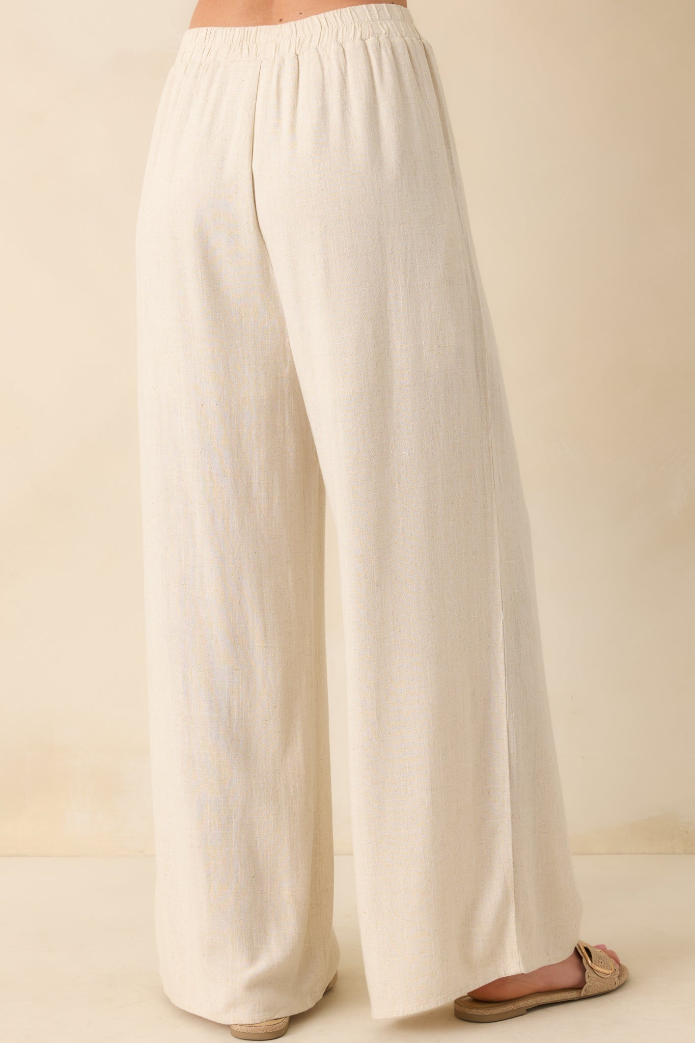 Back view of the pants showing the elastic waist and subtle shaping through the seat and upper leg.