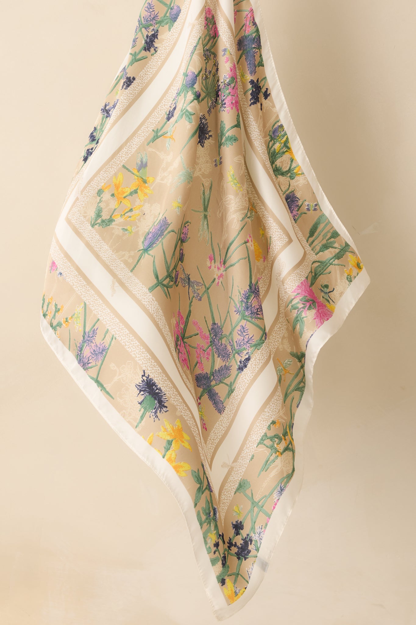 A close-up detail of the scarf’s satin finish, showing the sheen of the fabric and crisp floral print.